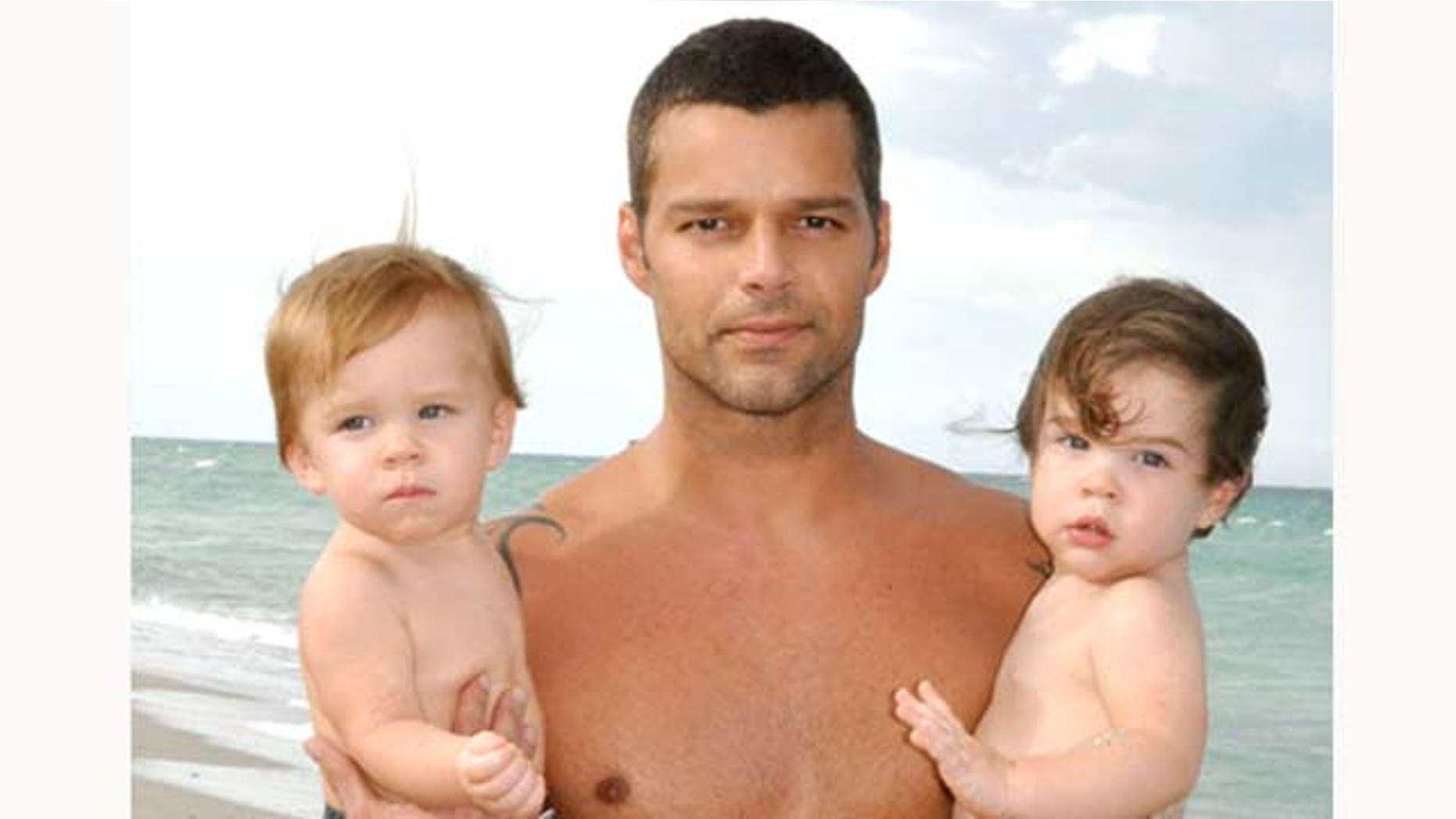 In this handout image provided by Ricky Martin, Ricky Martin poses with his sons Valentino and Matteo on August 18, 2009 in Miami, Florida.
