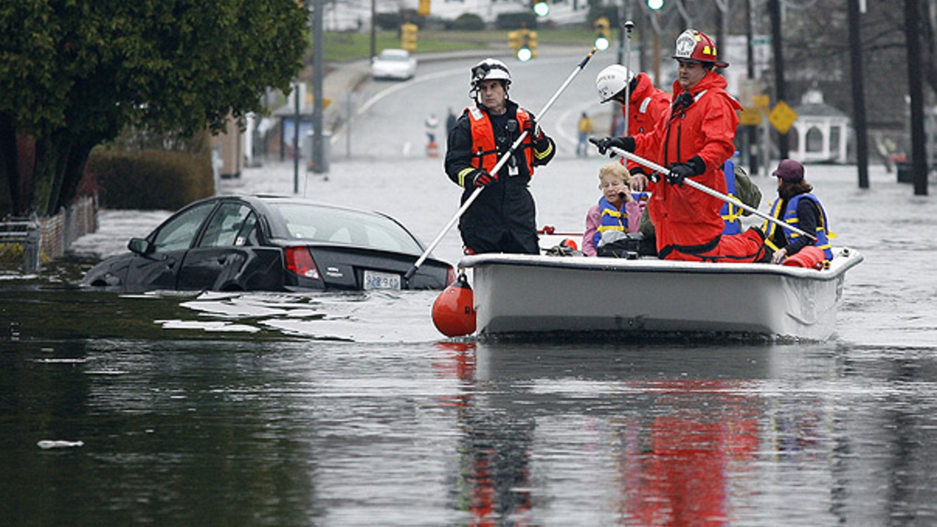 Mar. 30: West Warwick, R.I., firefighters evacuate residents from their flooded houses near the Pawtuxet River.
