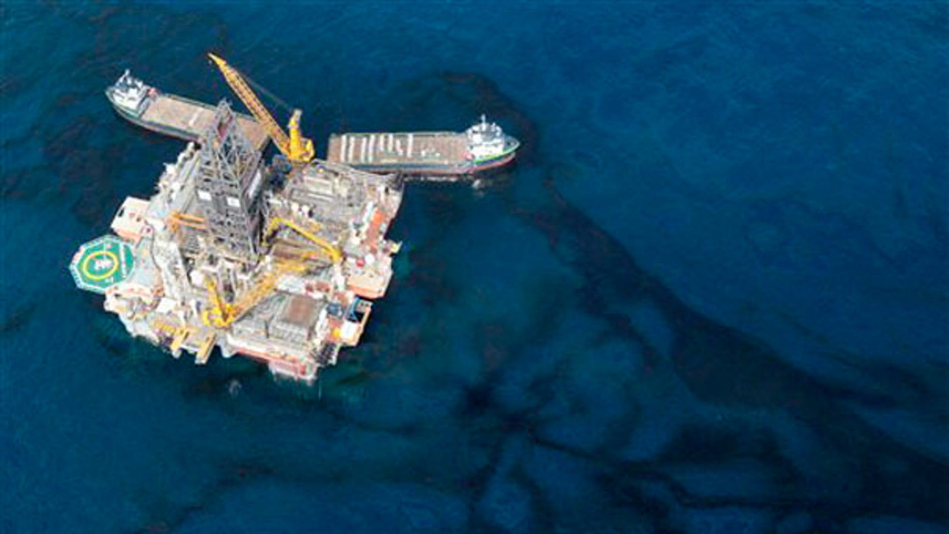 Oil floats around a rig at the site of the Deepwater Horizon oil spill in the Gulf of Mexico May 31. (AP Photo)