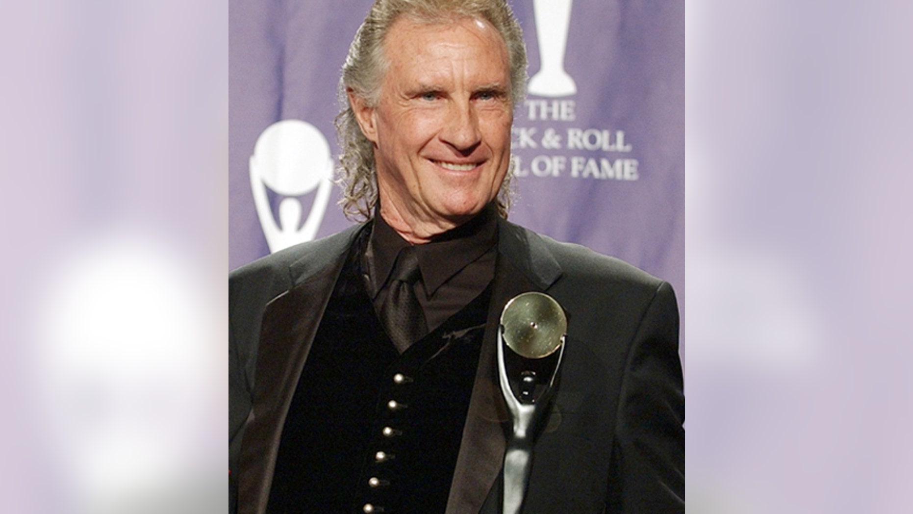 In this March 10, 2003 file photo, Bill Medley, one half of the famed Righteous Brothers singing duo, poses for photographers after being inducted into the Rock and Roll Hall of Fame in New York.