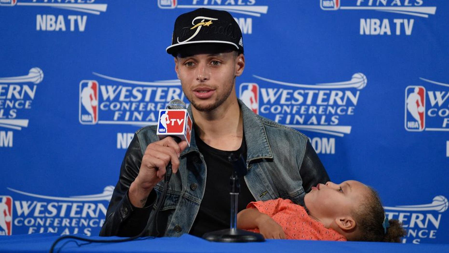 May 27, 2015; Oakland, CA, USA; Golden State Warriors guard Stephen Curry (30) and Riley Curry address the media in a press conference after game five of the Western Conference Finals of the NBA Playoffs against the Houston Rockets at Oracle Arena. Mandatory Credit: Kyle Terada-USA TODAY Sports
