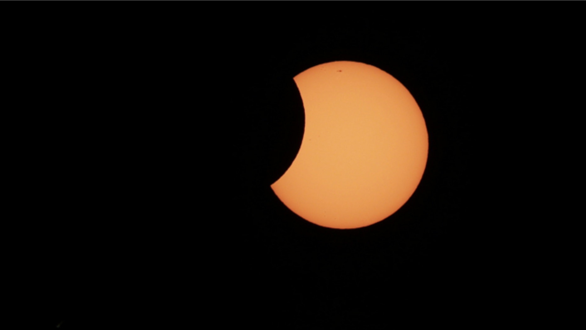 May 10, 2013: The moon begins to cross in front of the sun during a partial solar eclipse in Sydney.