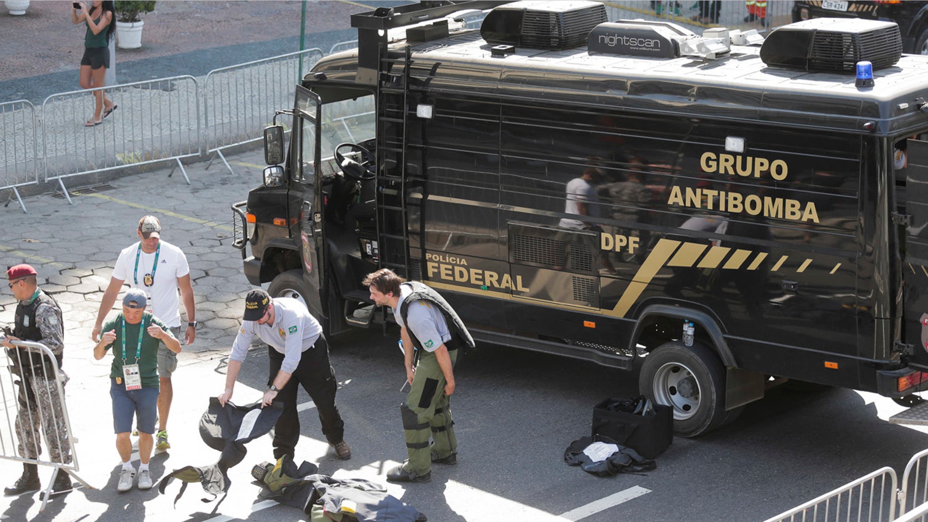 Aug. 6, 2016: Members of Brazilian federal police bomb squad pack their gear after detonating a suspicious package near the men's cycling road race final on Copacabana beach at the 2016 Summer Olympics in Rio de Janeiro, Brazil
