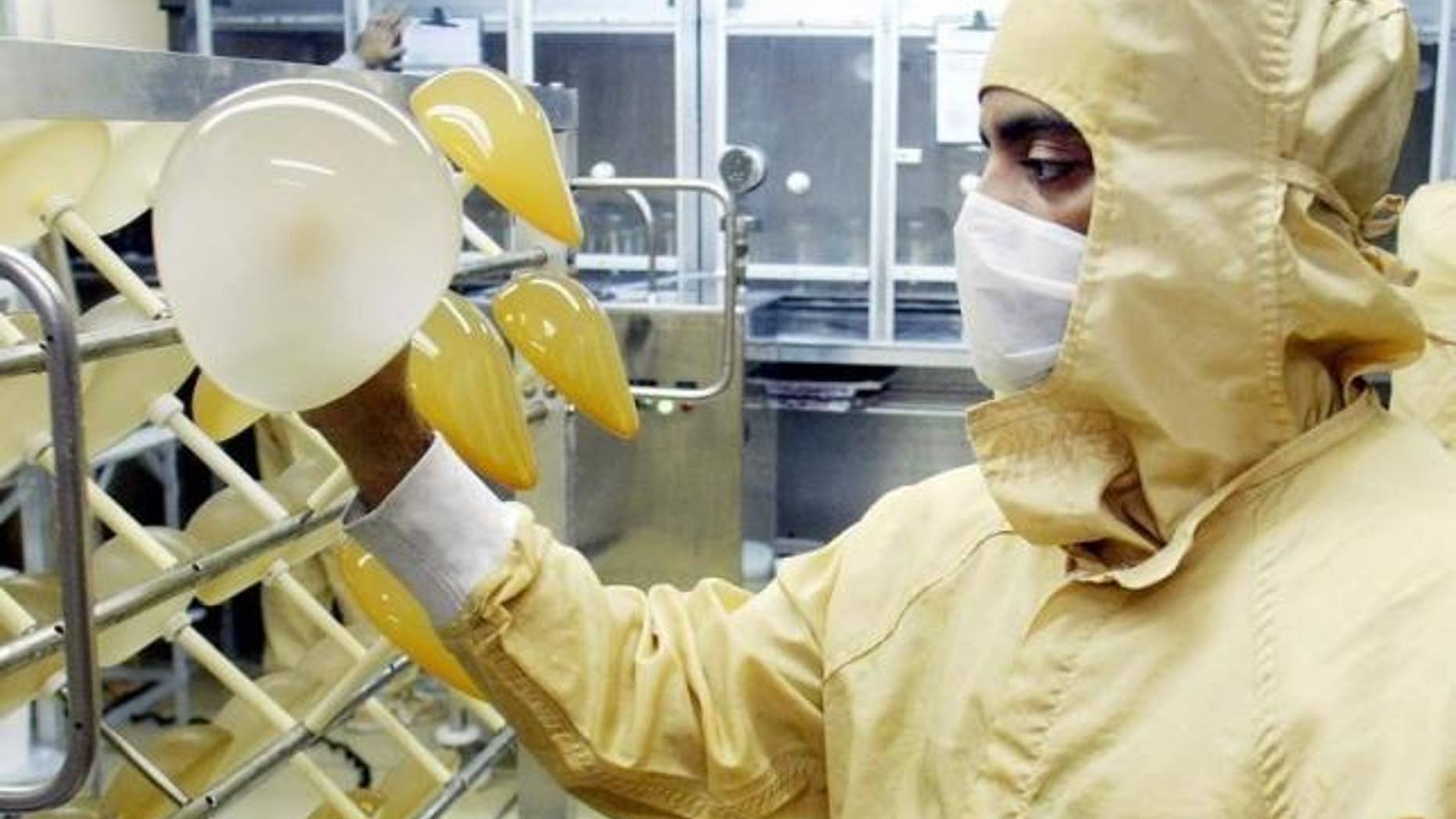 March 27, 2003: A laboratory worker of Silimed factory checks silicone implants at a factory in Rio de Janeiro.