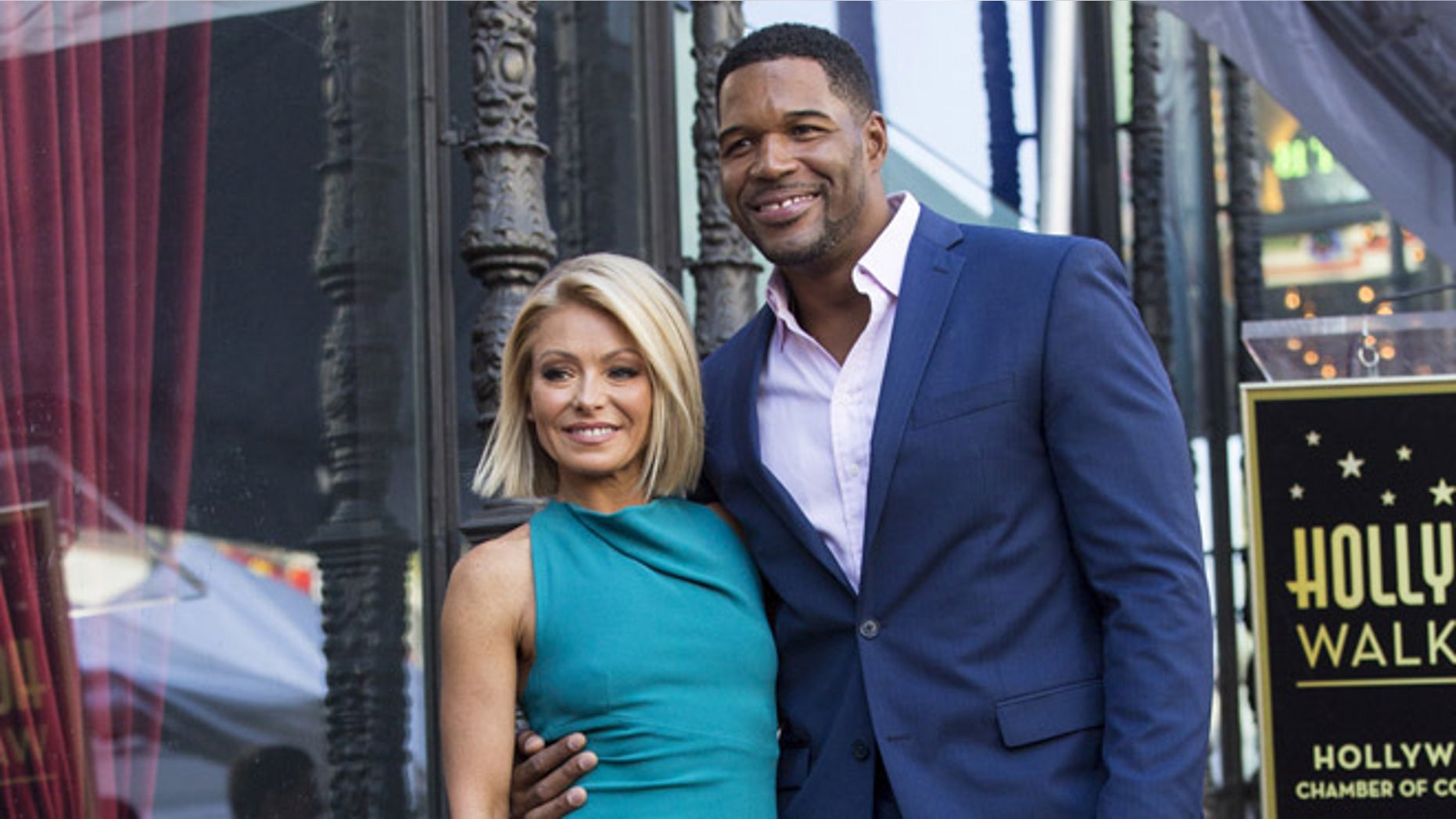 Michael Strahan joins Kelly Ripa as she receives a star on the Hollywood Walk of Fame in 2015.