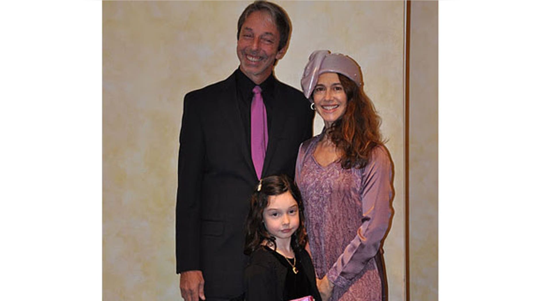 Leigh Devine, with her husband and daughter, Harper, 6.
