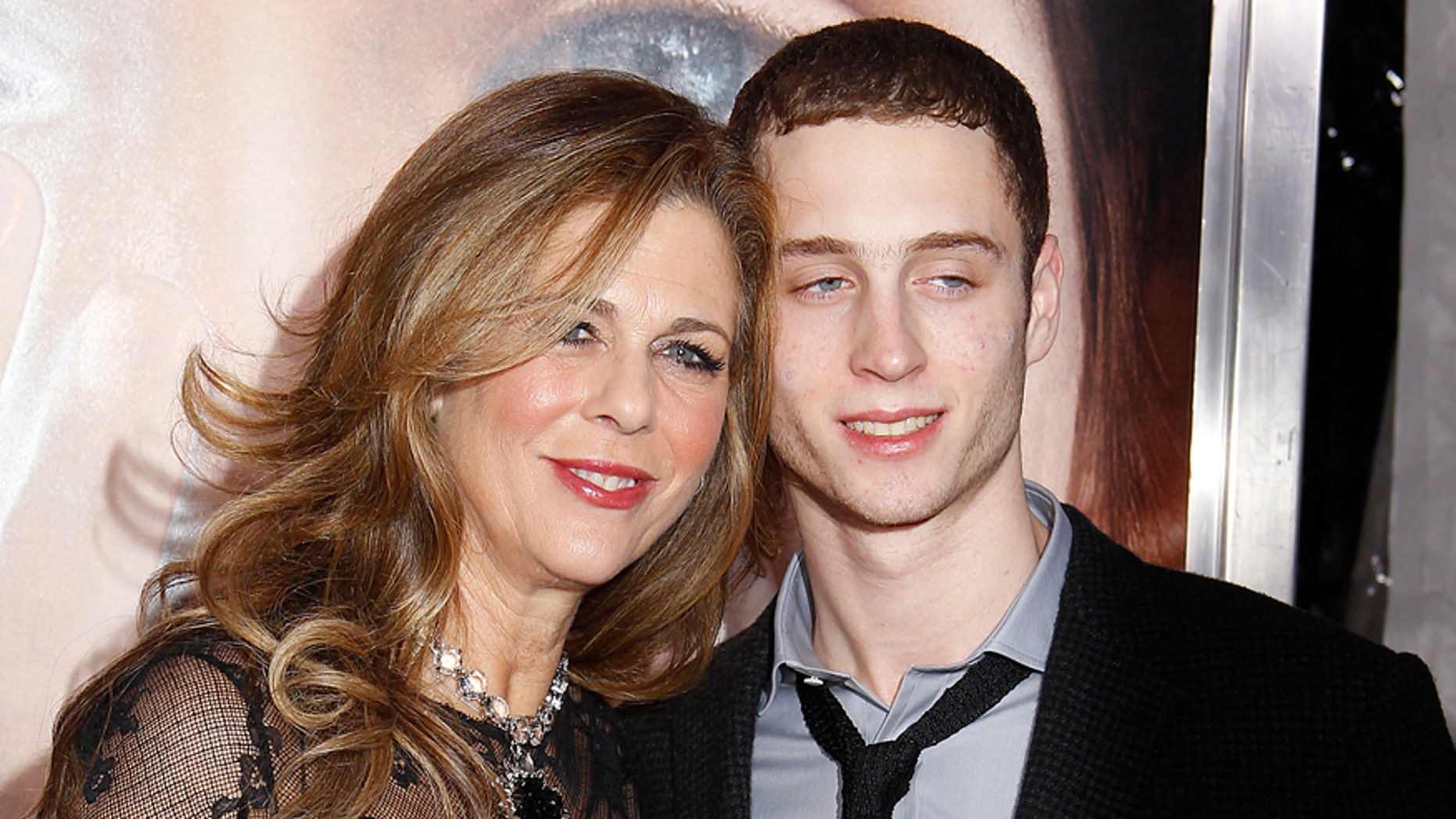 Actress Rita Wilson and son Chester Hanks (R) arrive for the premiere of the film "Extremely Loud and Incredibly Close" in New York, December 15, 2011. REUTERS/Carlo Allegri (UNITED STATES - Tags: ENTERTAINMENT) - RTR2VAYE