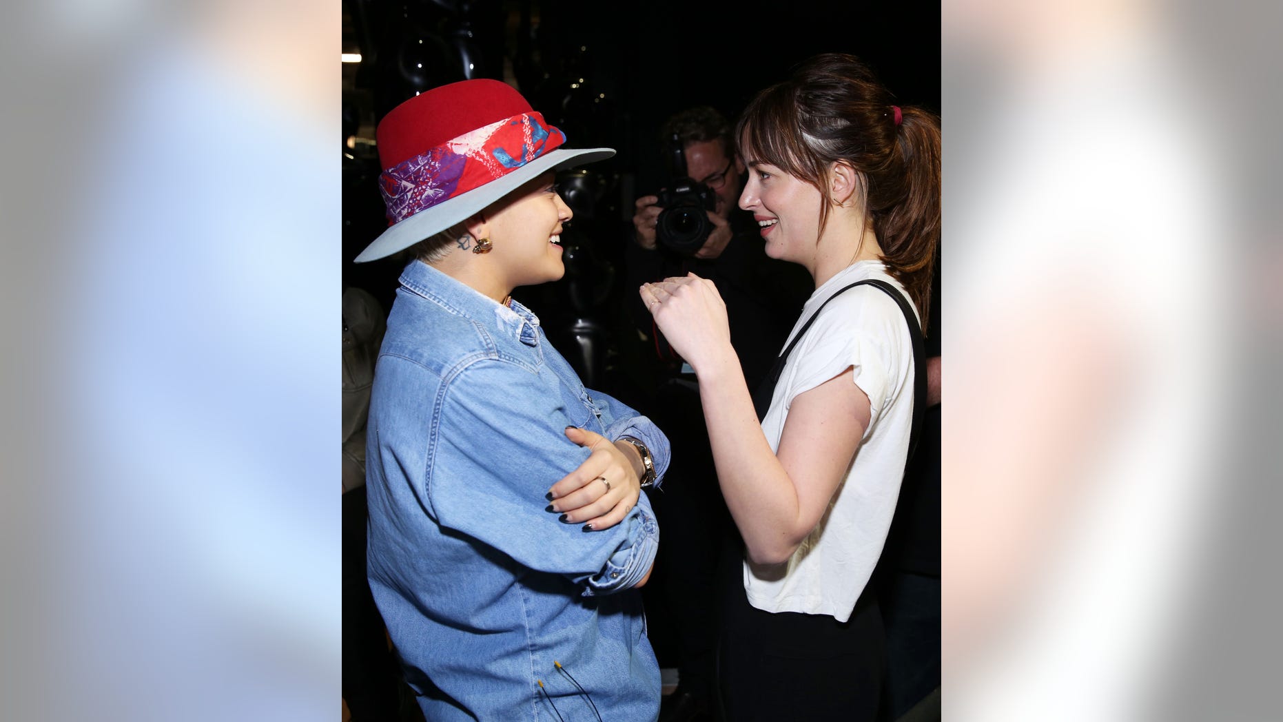 Feb 20, 2015. Rita Ora, left, and Dakota Johnson speak with each other backstage during rehearsals for the 87th Academy Awards in Los Angeles.