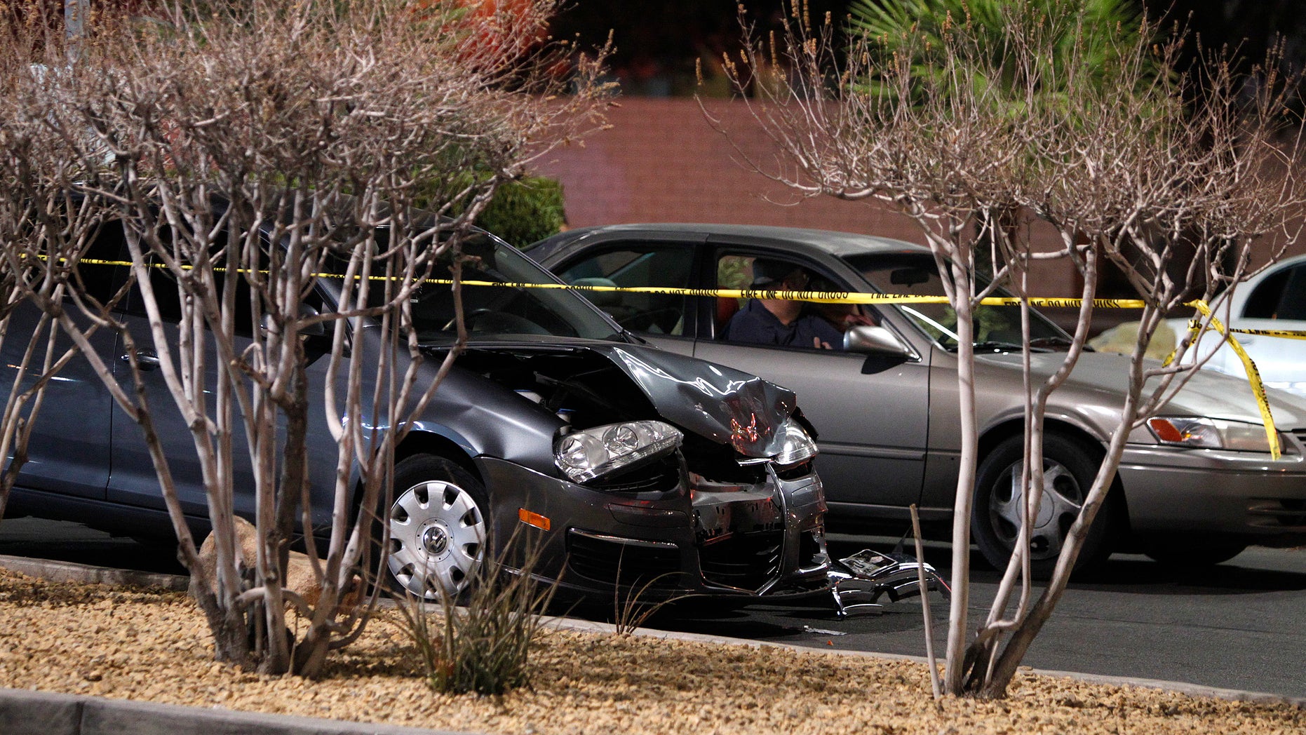 FILE - In this Jan. 21, 2014 file photo, a damaged car is seen at the scene of a fatal road rage incident near the corner of Tropicana Avenue and Rainbow Boulevard in Las Vegas. Authorities say a man shot a motorist to death in a vehicle with two children in the backseat in an apparent road-rage confrontation during rush-hour several miles west of the Las Vegas Strip. Nearly eight of every 10 U.S. drivers admit expressing anger, aggression or road rage at least once in the previous year, according to a new survey released Thursday, July 13, 2016, by the AAA Foundation for Traffic Safety. It could be following too closely, yelling at another driver, cutting them off or making angry gestures. (John Locher/Las Vegas Review-Journal via AP, File)