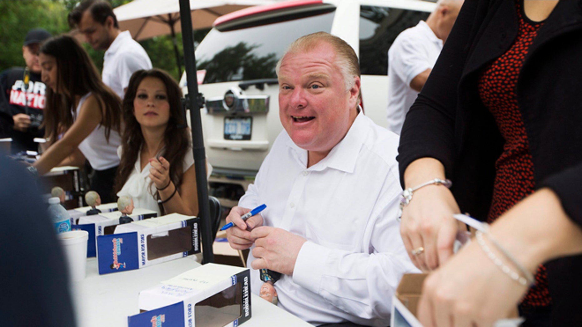 Sept. 1, 2014: Toronto Mayor Rob Ford signs the third edition of "Robbie Bobbies" bobbleheads at his mother's home in Toronto.