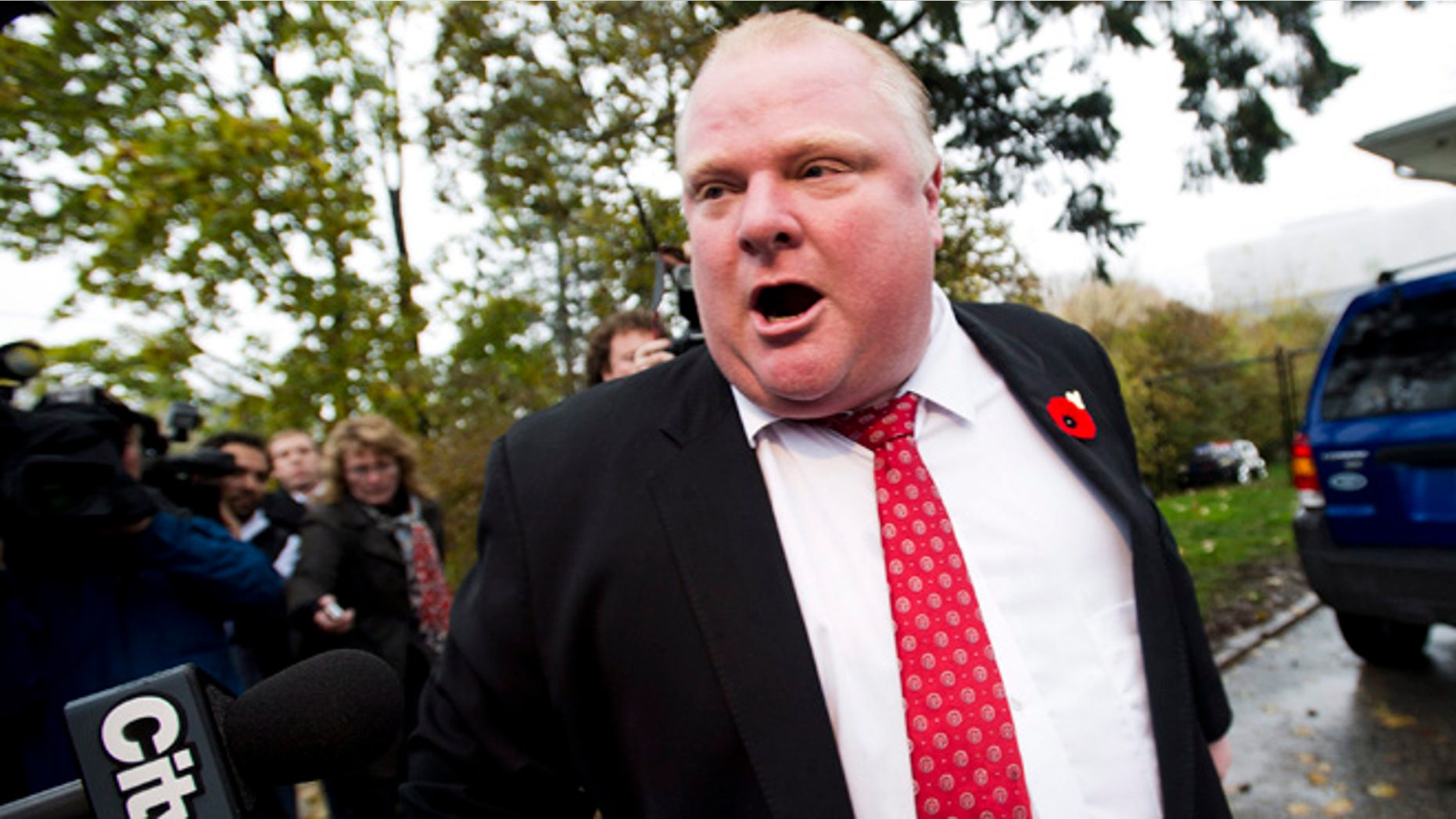 Oct. 31, 2013: In this file photo, Toronto Mayor Rob Ford tells to the media to get off his property as he leaves his home in Toronto.