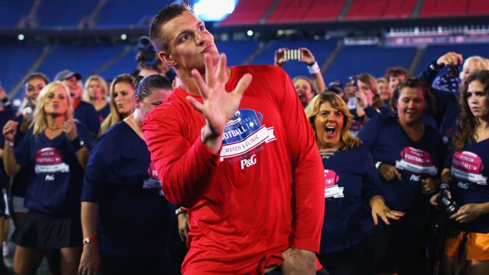 FOXBORO, MA - SEPTEMBER 28: Rob Gronkowski #87 of the New England Patriots dances with clinic participants during The Rob Gronkowski Football 101 Women's Clinic at Gillette Stadium on September 28, 2015 in Foxboro, Massachusetts. The clinic aimed to teach women fundamental football skills and rules of the game. (Photo by Maddie Meyer/Getty Images)