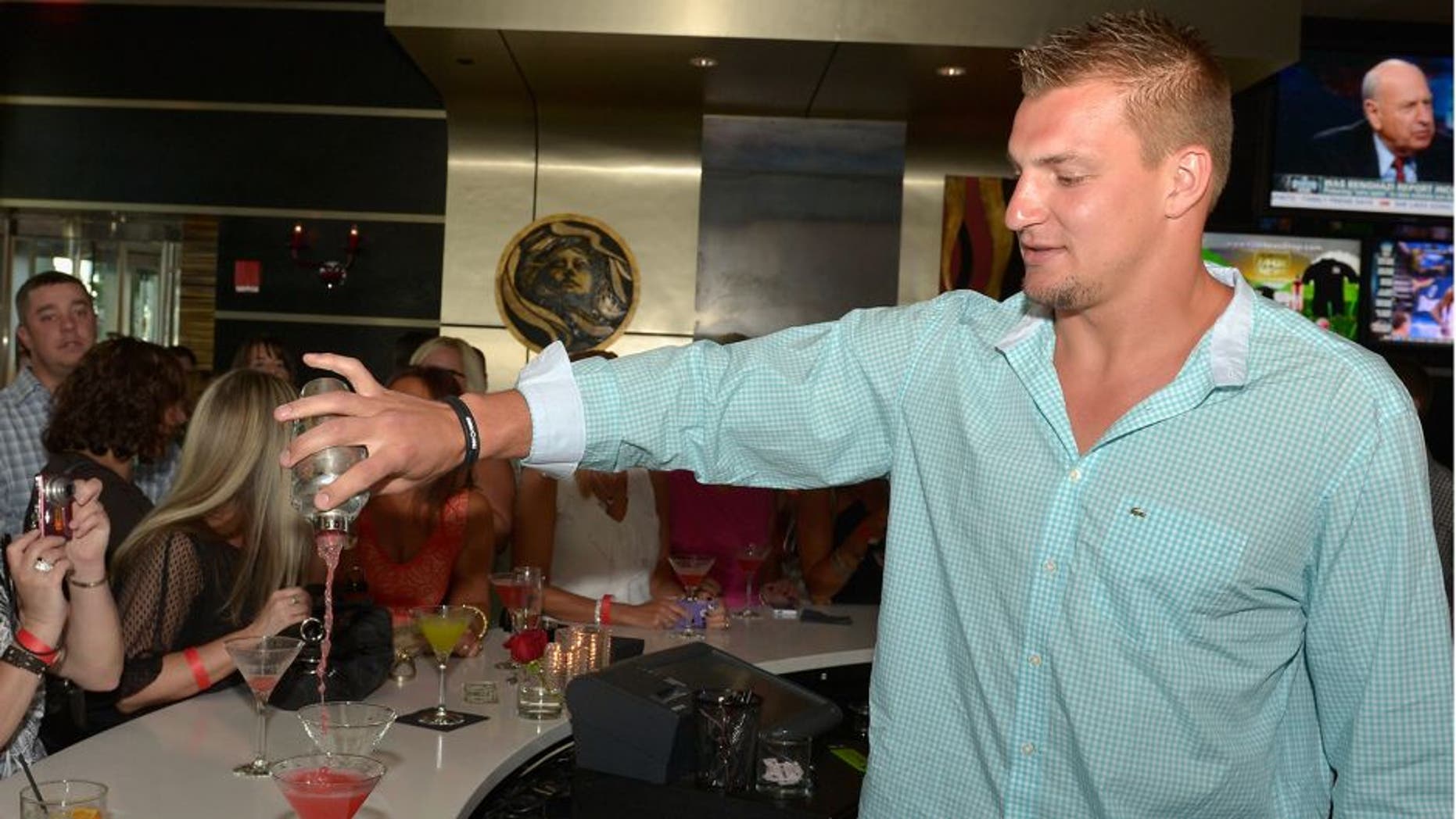 BOSTON, MA - MAY 13: Rob Gronkowski of the New England Patriots serves guests at "Shaking It Up" Event Benefiting The One Fund Boston at Strega Water Front Bar on May 13, 2013 in Boston, Massachusetts. (Photo by Paul Marotta/Getty Images)