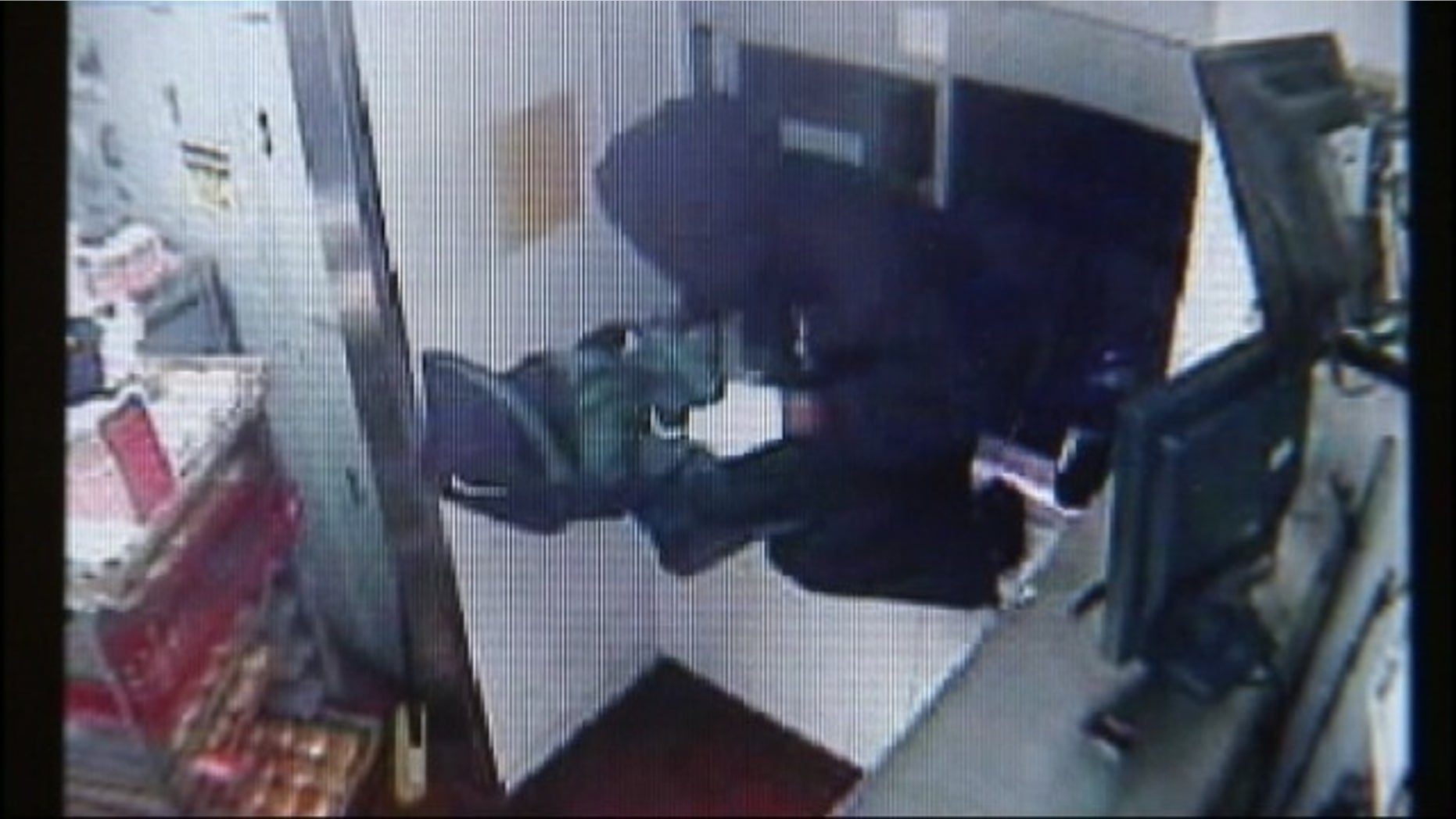 This screen shot of surveillance video shows a suspect jumping through a McDonald's drive-thru window.