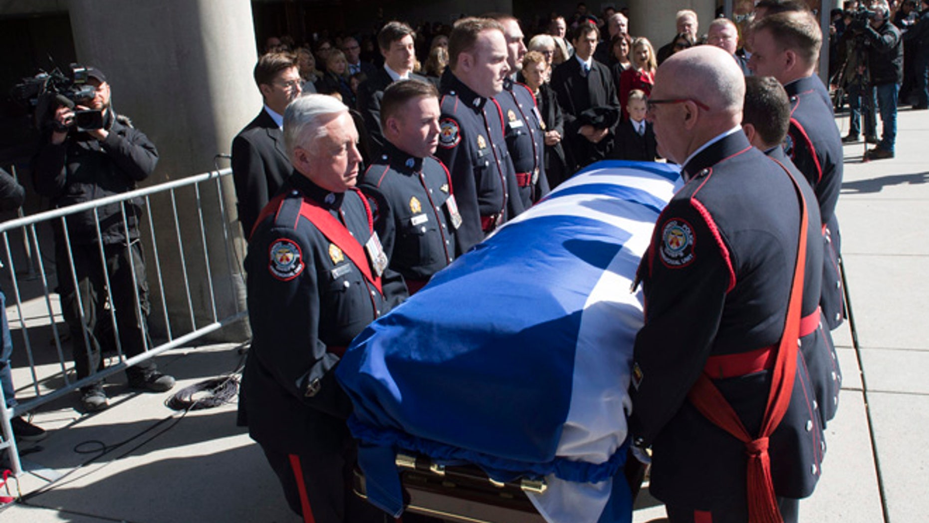 Pallbearers carry the casket of former Toronto mayor Rob Ford from city hall during his funeral procession to St. James Cathedral in Toronto on Wednesday.