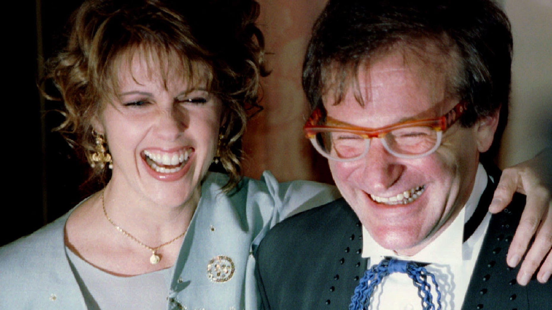 Actress Pam Dawber (L) shares a laugh with actor Robin Williams as they pose for photographers before the annual American Museum of the Moving Image Tribute dinner February 23, 1995 in New York. Williams and Dawber stared in the TV show "Mork and Mindy". Williams is this years honoree at the tribute REUTERS/Jeff Christensen - RTXG84Q