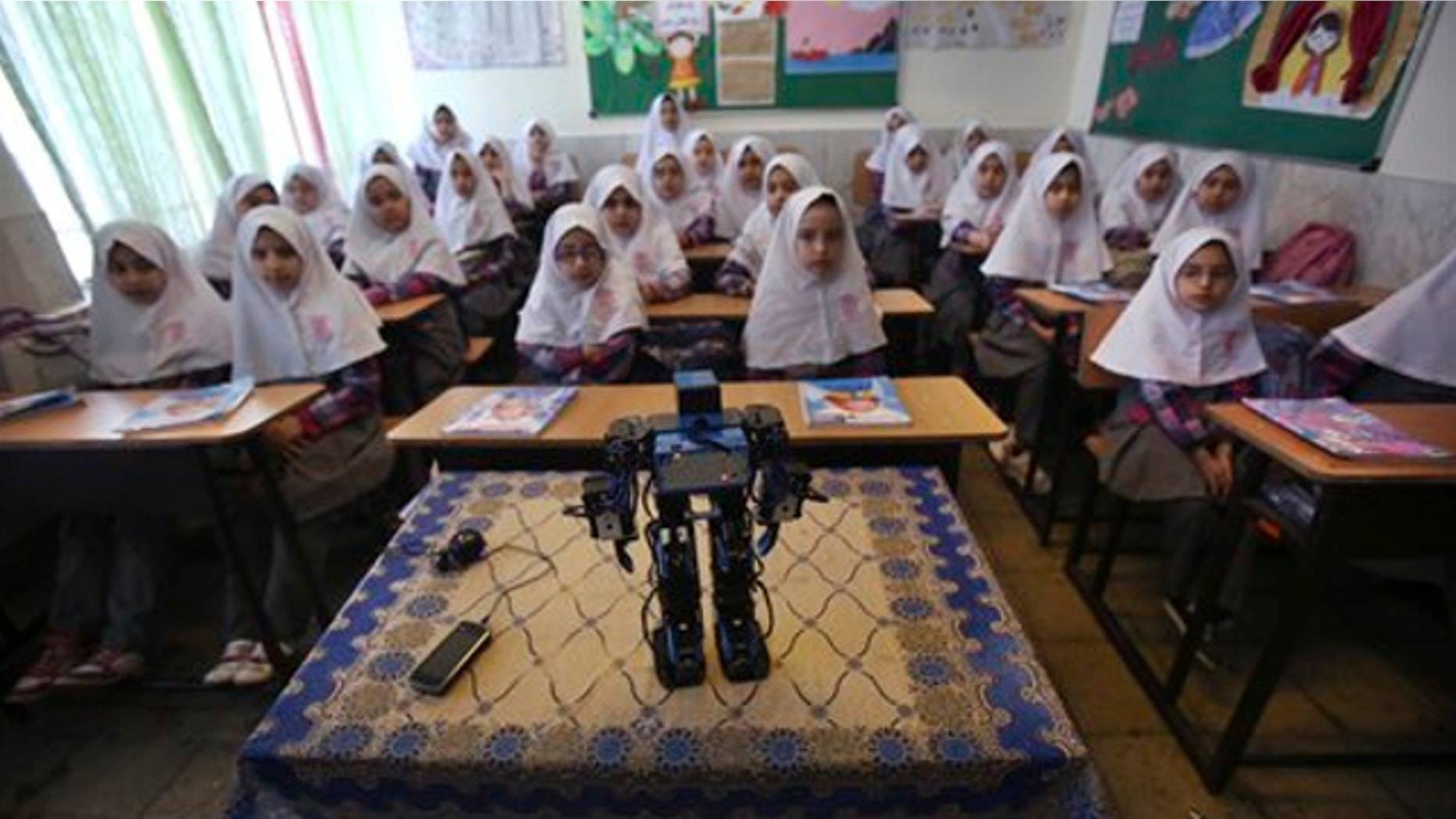 Feb. 24, 2014: Veldan, a humanoid praying robot which is built by Iranian schoolteacher Akbar Rezaie, performs morning prayer in front of Alborz elementary school girls in the city of Varamin some 21 miles south of the capital Tehran, Iran.