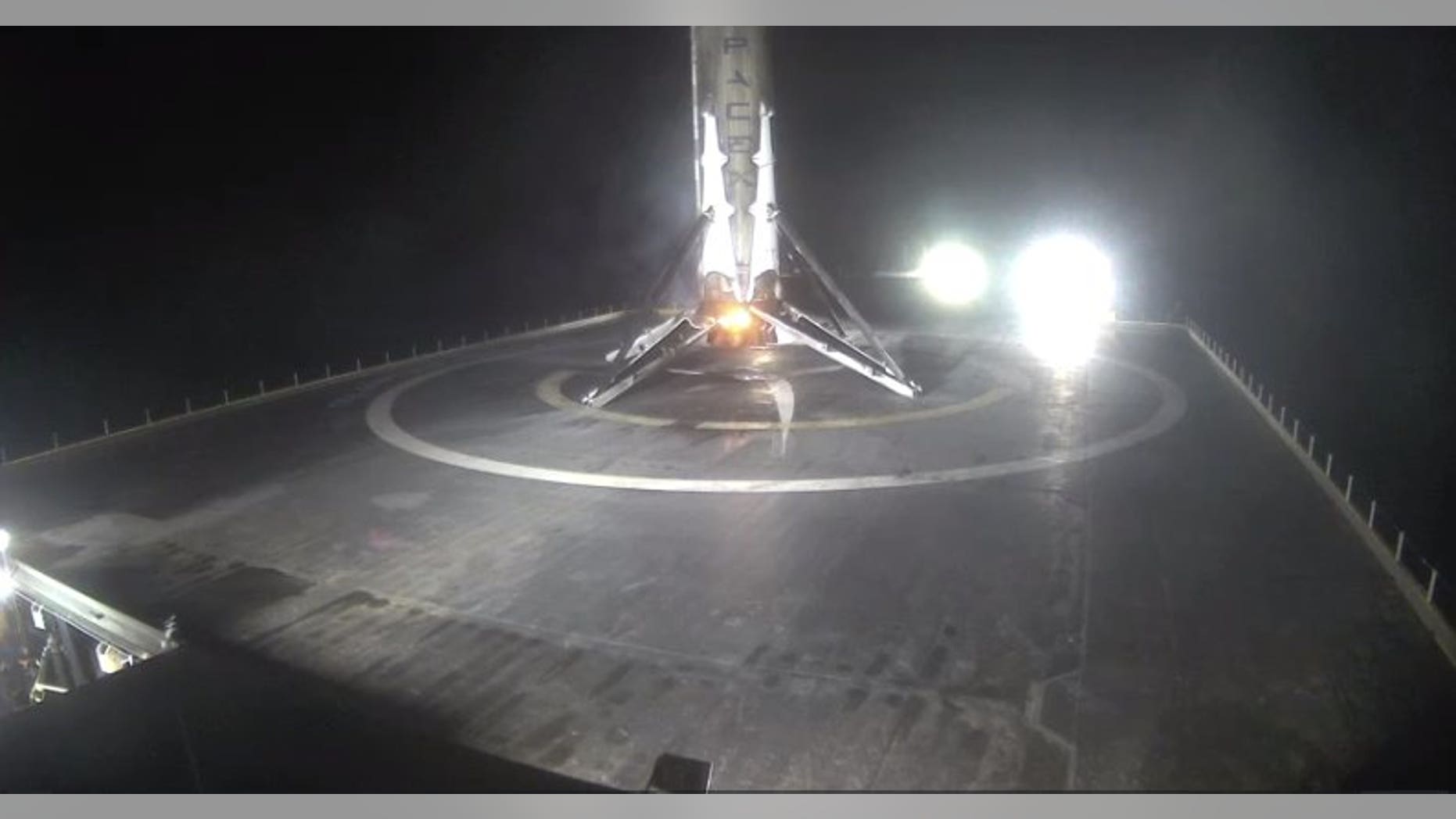 The first stage of SpaceX's Falcon 9 rocket rests on the deck of a robotic ship called "Of Course I Still Love," seconds after touching down on Aug. 14, 2016.