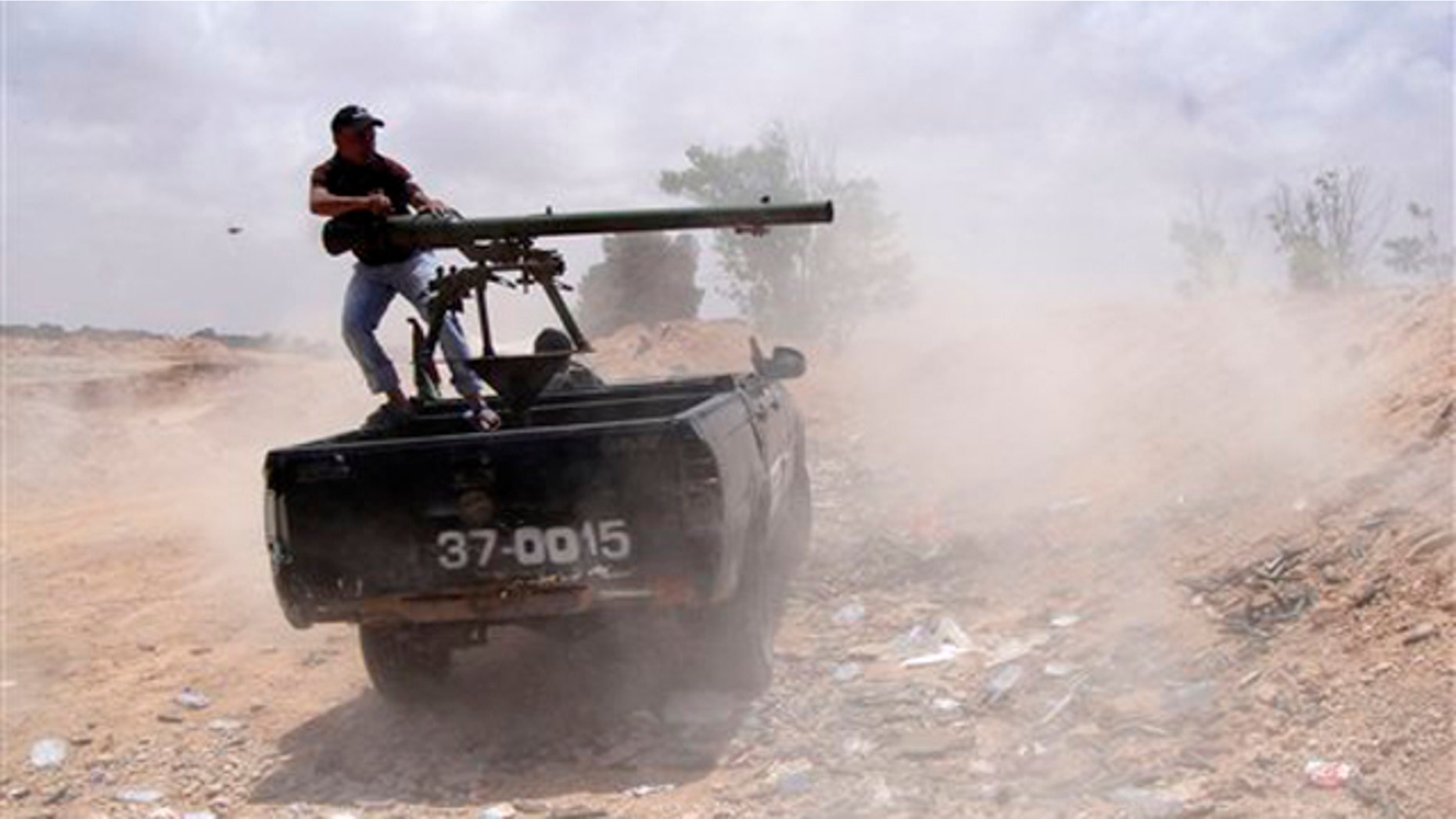 Libyan rebel fires a rocket toward pro-Muammar Qaddafi forces on the front line of Dafniya in Misrata, Libya, June 21.