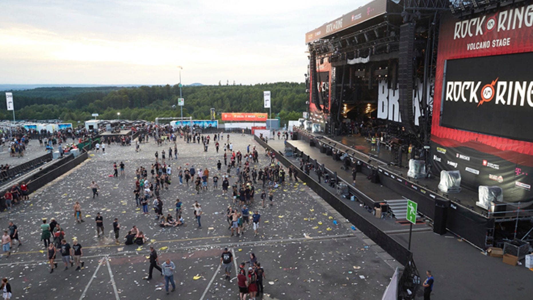 Visitors leave the music festival Rock am Ring outside the western town of Nuerburg, Germany, Friday, June 2, 2017. German authorities have shut down a popular music festival after uncovering a possible terrorist threat. (Thomas Frey/Dpa via AP)