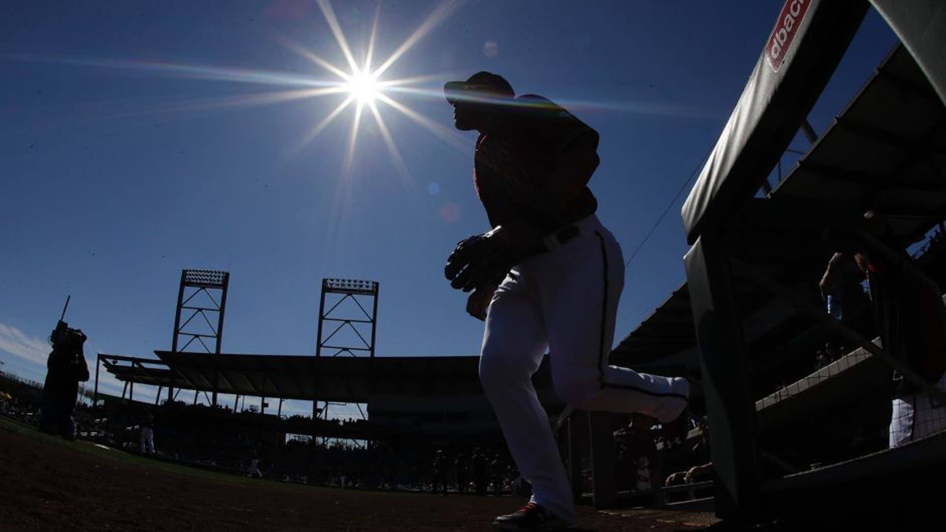 Members of the Arizona Diamondbacks take the field for a spring training baseball game against the Colorado Rockies in Scottsdale, Ariz., Saturday, Feb. 25, 2017. (AP Photo/Chris Carlson)