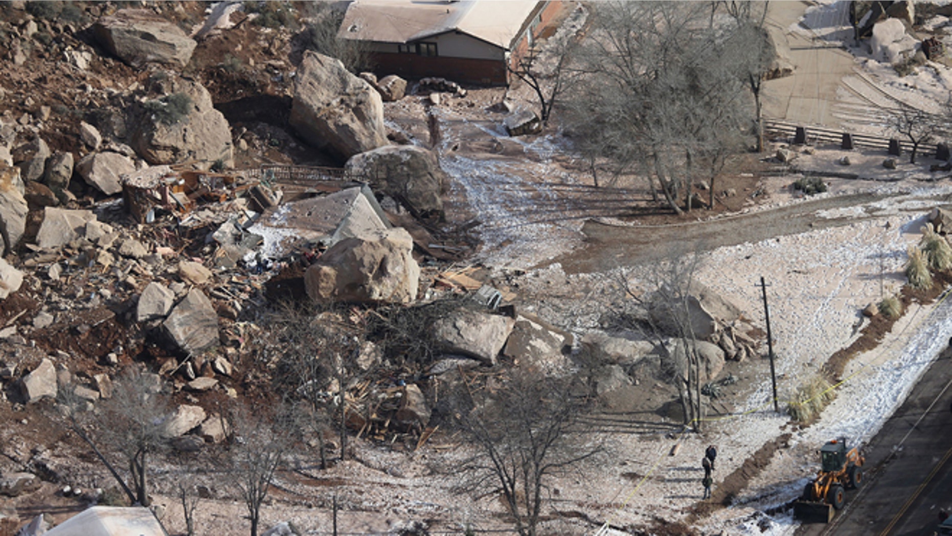 Dec. 13, 2013: In this photo,officials survey the boulders from a rock slide that crushed a home and killed two people, in Rockville, Utah.