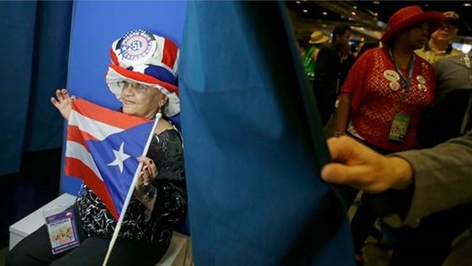 Sept. 5, 2012: New York delegate Julia Rodriguez poses with a Puerto RIco flag in Charlotte, N.C.