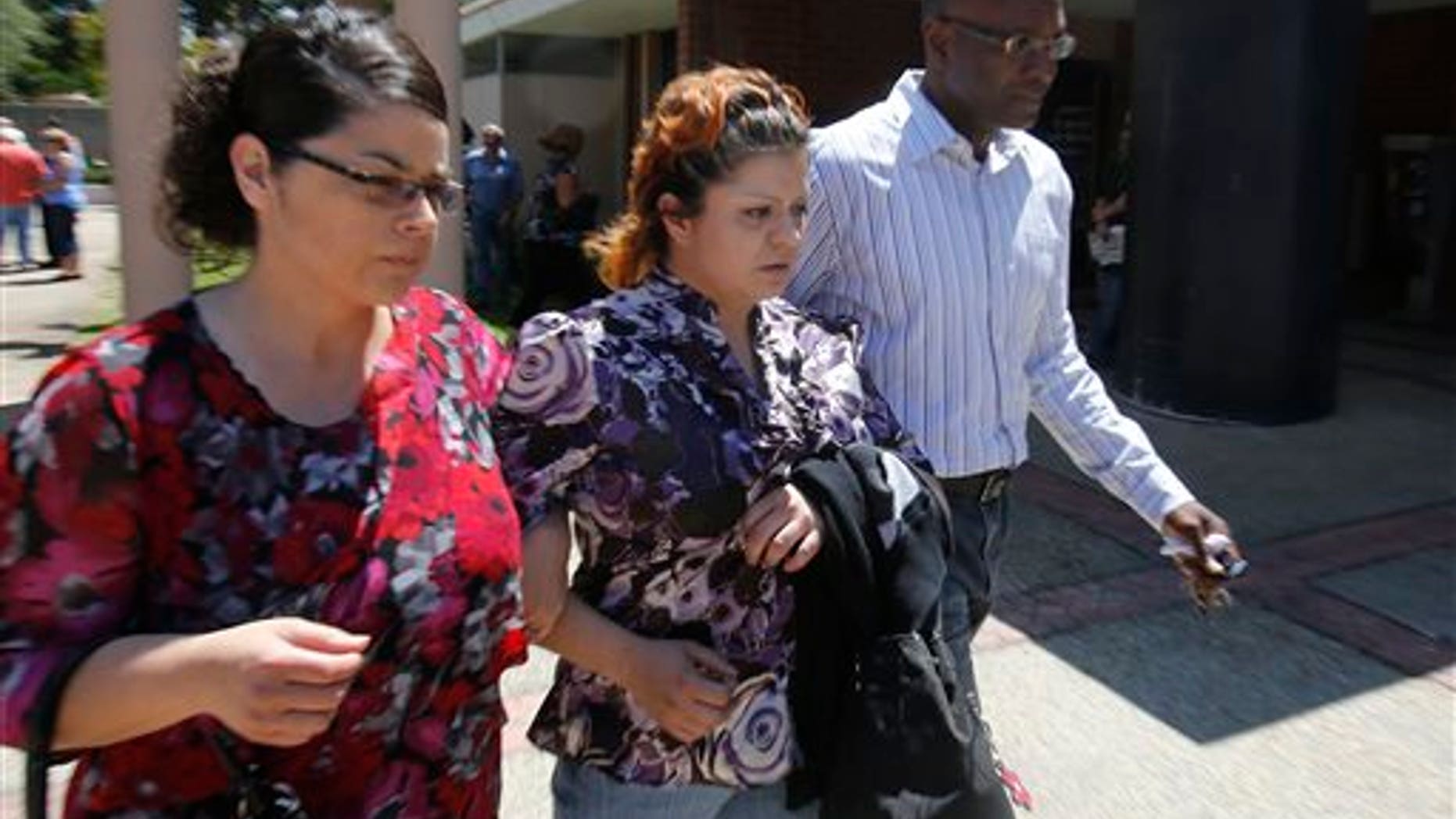 Priscilla Rodriquez, center, the mother of murder victim of Leila Fowler, leaves the Calaveras County Courthouse, in San Andreas, Calif., after the arraignment of her 12-year-old son for Leila's murder, Wednesday, May 15, 2013. Leila Fowler, 8, was stabbed to death in her Valley Springs home, last month. The defendant was charged with second-degree murder and a special allegation for use of a dangerous weapon for the death of Leila Fowler. No plea was entered. (AP Photo/Rich Pedroncelli)