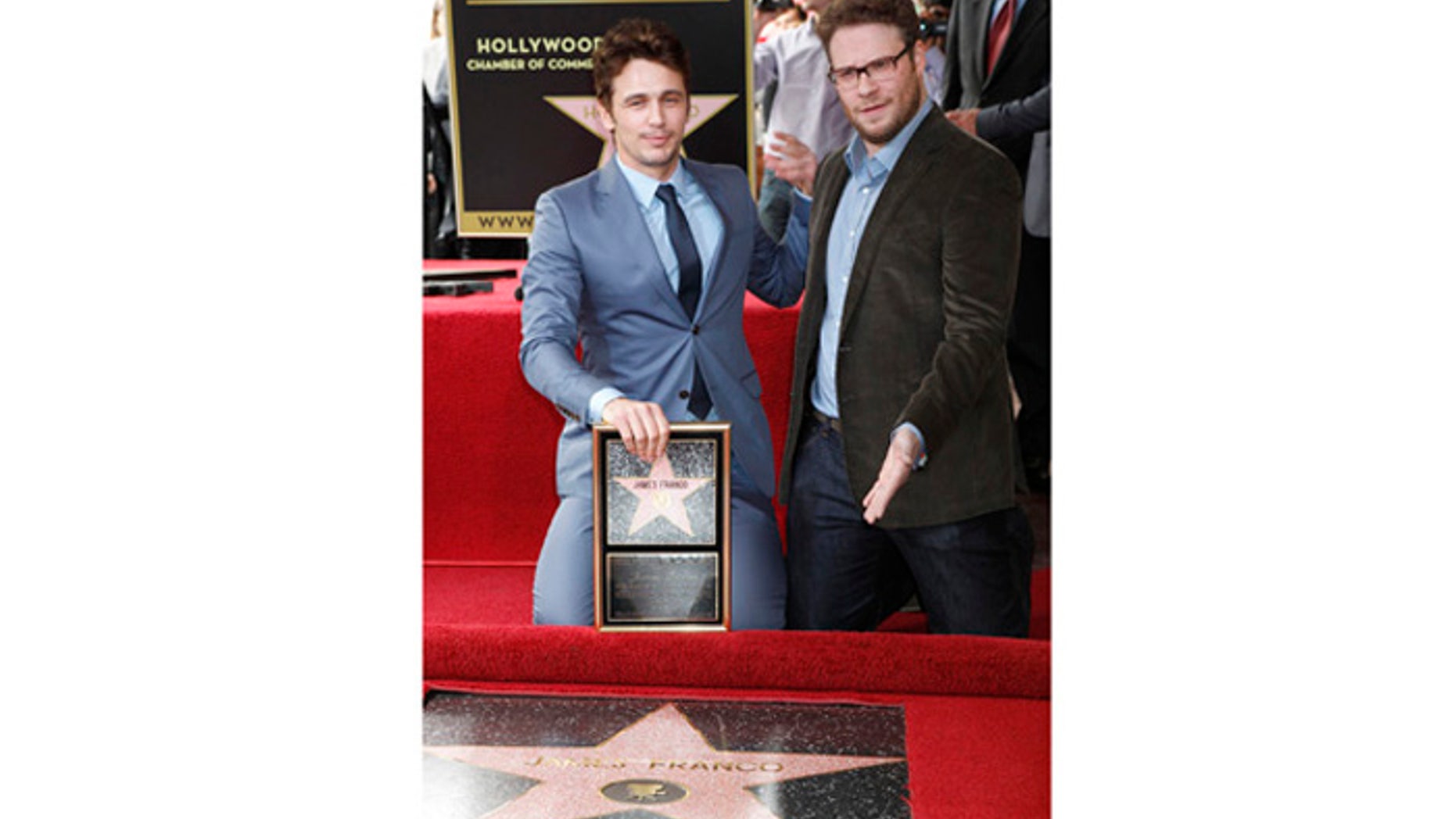 Actor James Franco (L) poses with his newly unveiled star on the Hollywood Walk of Fame, with actor Seth Rogen March 7, 2013. REUTERS/Fred Prouser (UNITED STATES - Tags: ENTERTAINMENT) - RTR3EPGG