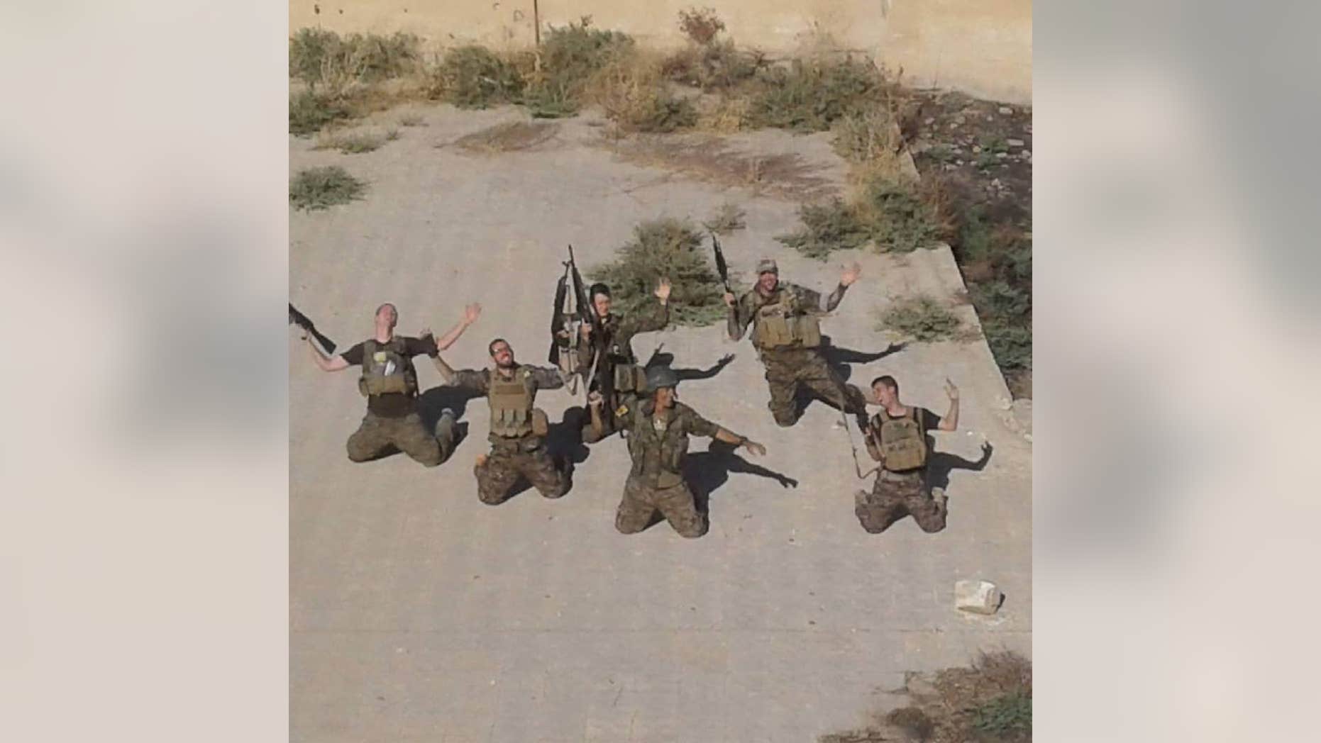 Western volunteers with the YPG posing at their base in the Rojava region of Syria.