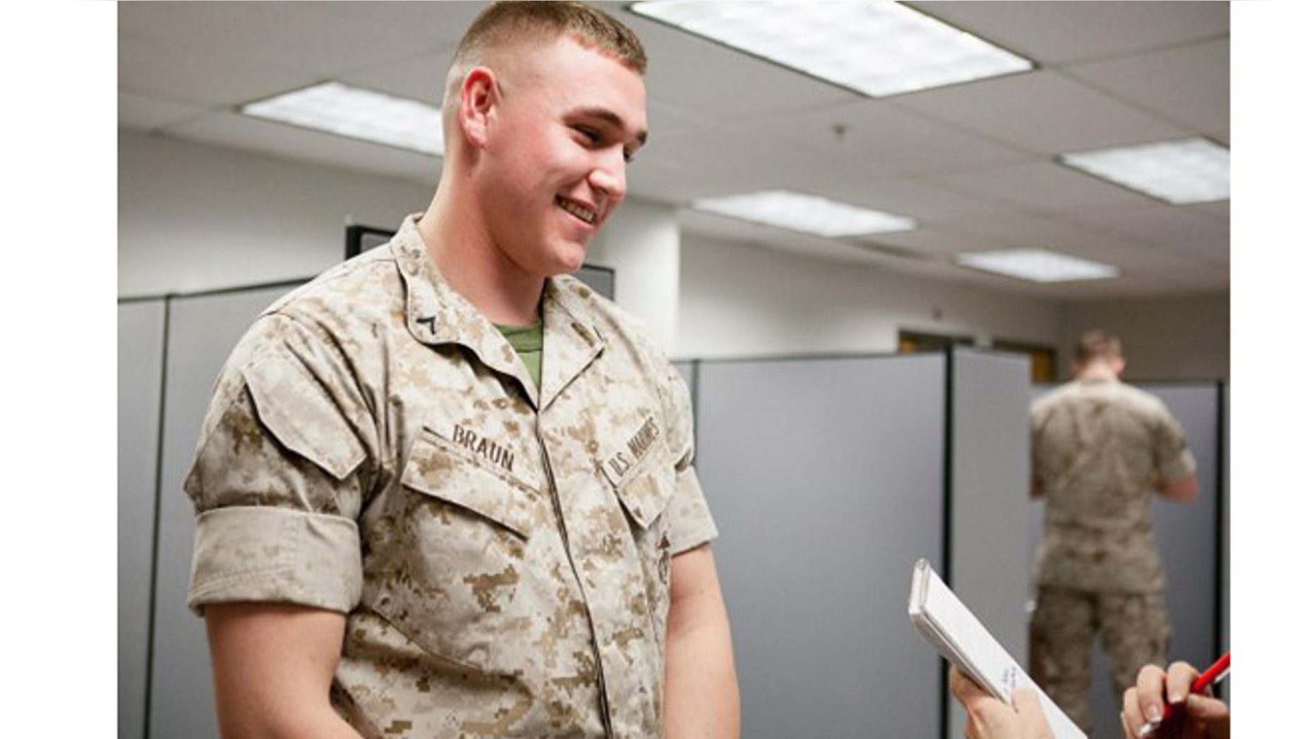 Marine Pfc. Austin Braun talks to a reporter about rolling sleeves at Fort Myer, Va., in 2014. (U.S. Army)