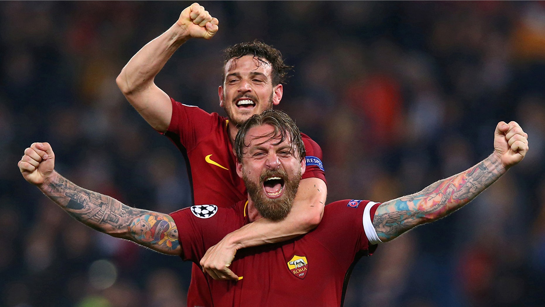 Roma's Daniele De Rossi and Alessandro Florenzi celebrate after the match against Barcelona at the Stadio Olimpico in Rome, Italy.