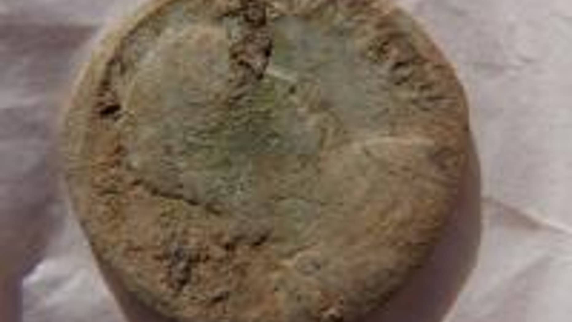The Roman coin found on the island of Rousay (Swandro-Orkney Coastal Archaeology Trust).