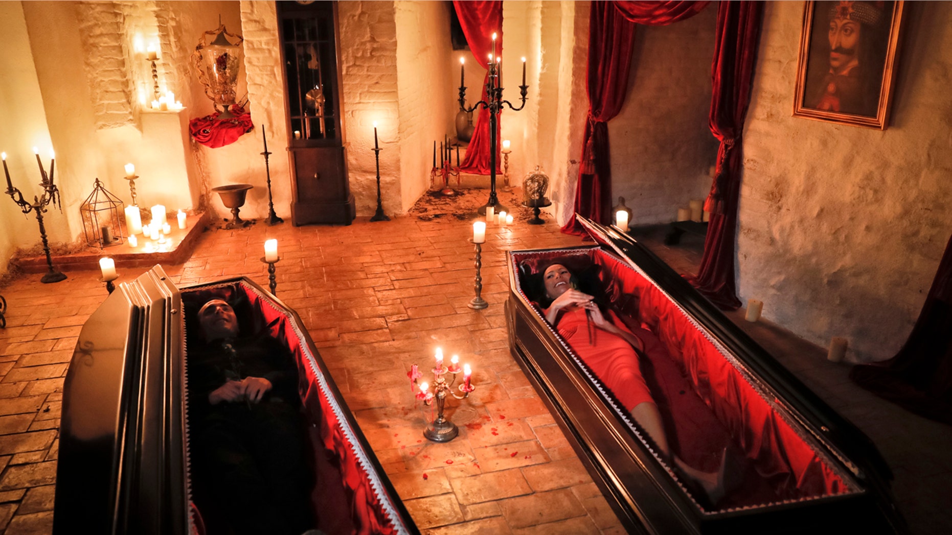 Tami Varma, right, and her brother Robin, the grandchildren of Devendra Varma, a scholar of English gothic tales and an expert in vampire lore, pose in coffins, at the Bran Castle, in Bran, Romania, Monday, Oct. 31, 2016.