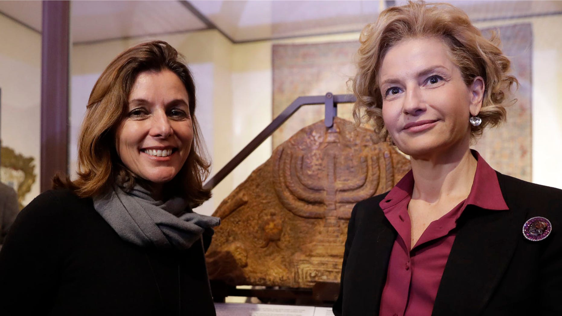 Feb. 20, 2017: Director of the Vatican Museums, Barbara Jatta, left, and Director of Rome's Jewish Museum Alessandra Di Castro pose for a photo in front of a bas-relief showing a menorah at the end of a press conference in Rome.