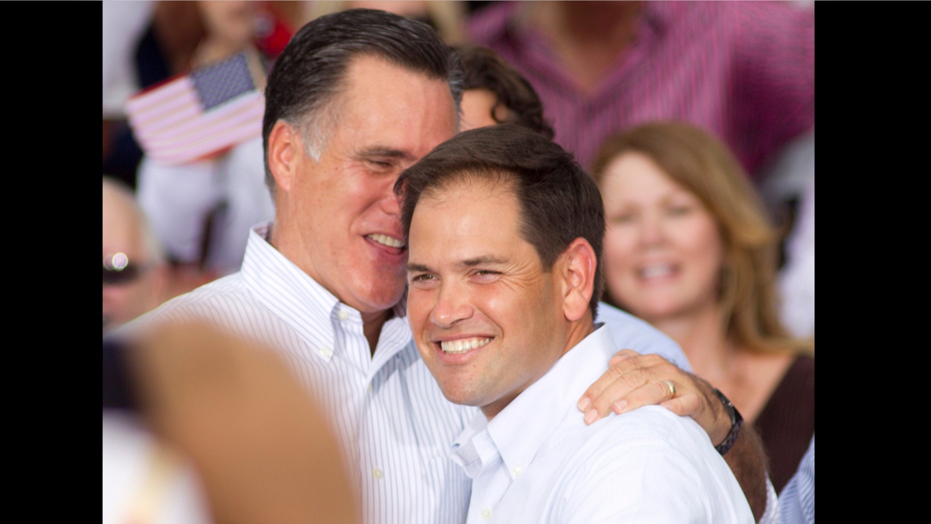 Mitt Romney, left, hugs U.S. Rep. Marco Rubio, (R-Fla.) after Rubio introduced him to the crowd during a campaign stop in Miami, Monday, Aug. 13, 2012. (AP Photo/J Pat Carter)
