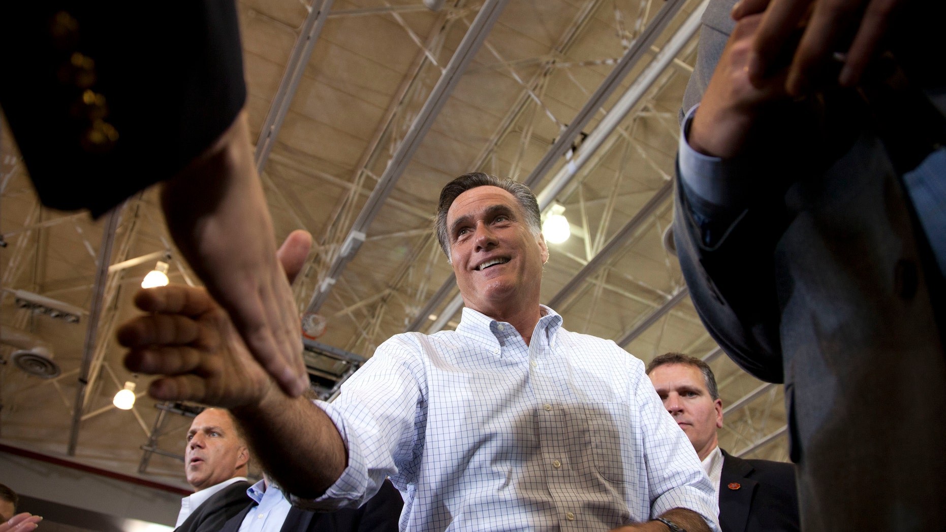 Sept. 7, 2012: Republican presidential candidate, former Massachusetts Gov. Mitt Romney shakes hands during a campaign rally in Orange City, Iowa.