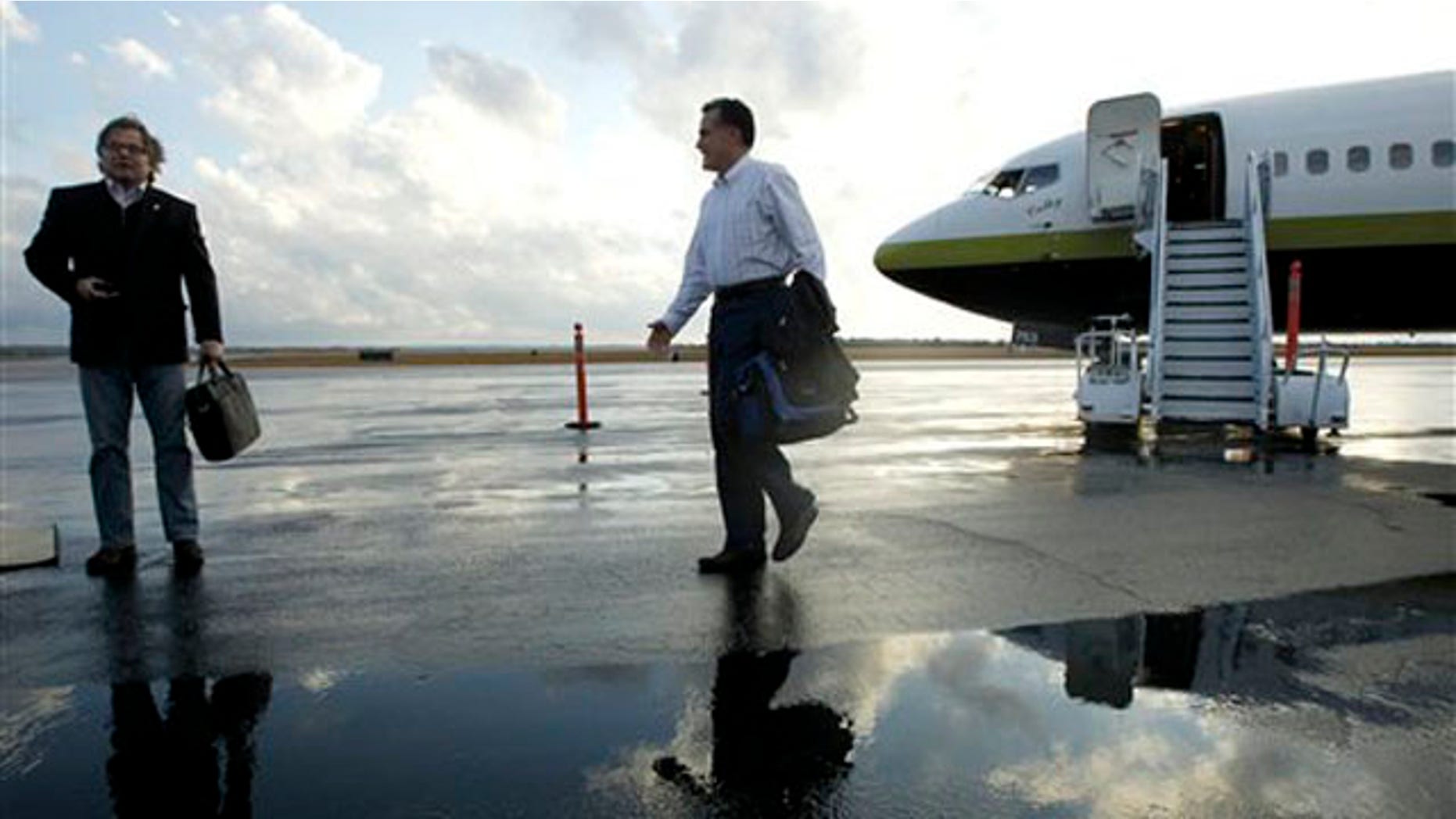 Jan. 11, 2012: Mitt Romney walks towards an adviser as they step off his campaign charter plane in Columbia, S.C.