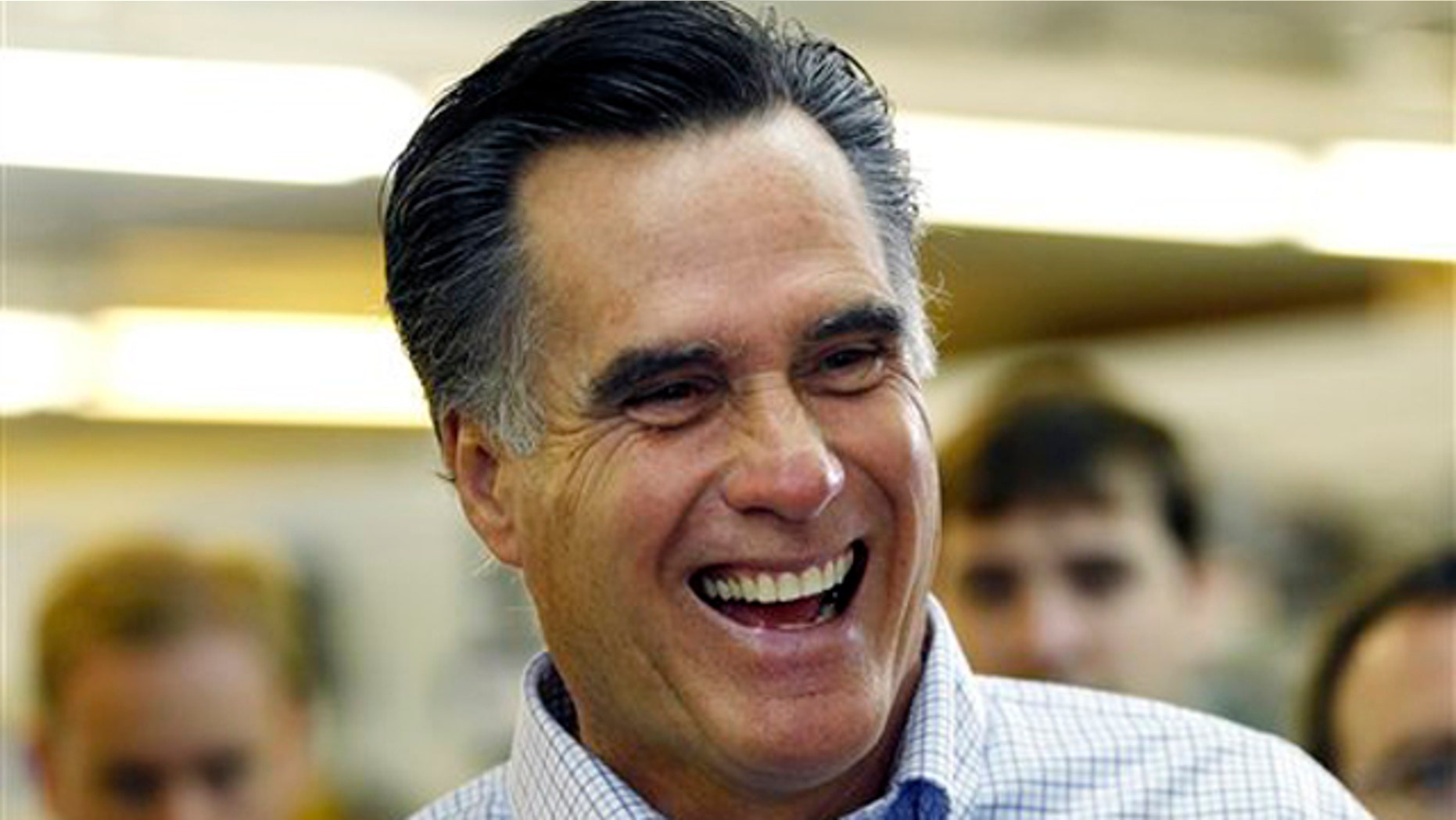 Former Massachusetts Gov. Mitt Romney laughs during a campaign stop at a hardware store in Derry, N.H., June 14.