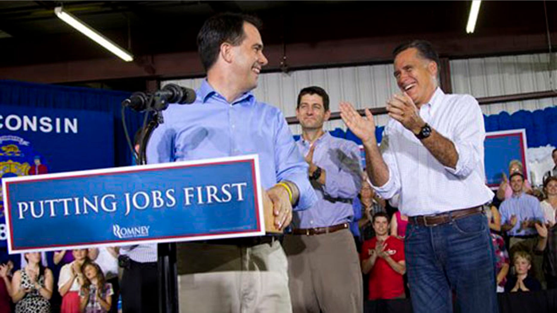 June 18, 2012: Mitt Romney, right, is introduced by Wisconsin Gov. Scott Walker, left, in Janesville, Wis.