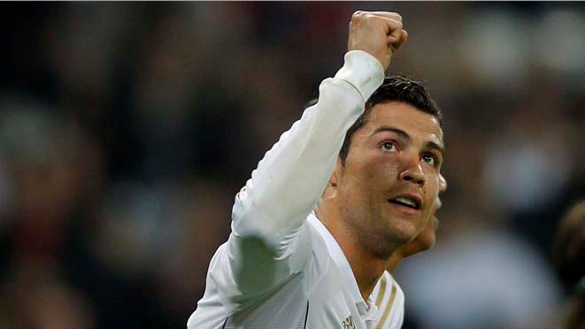 Real Madrid's Cristiano Ronaldo from Portugal celebrates his goal against APOEL Nicosia with during a second leg Champions League quarterfinal soccer match at the Santiago Bernabeu stadium, in Madrid, Wednesday, April 4, 2012.