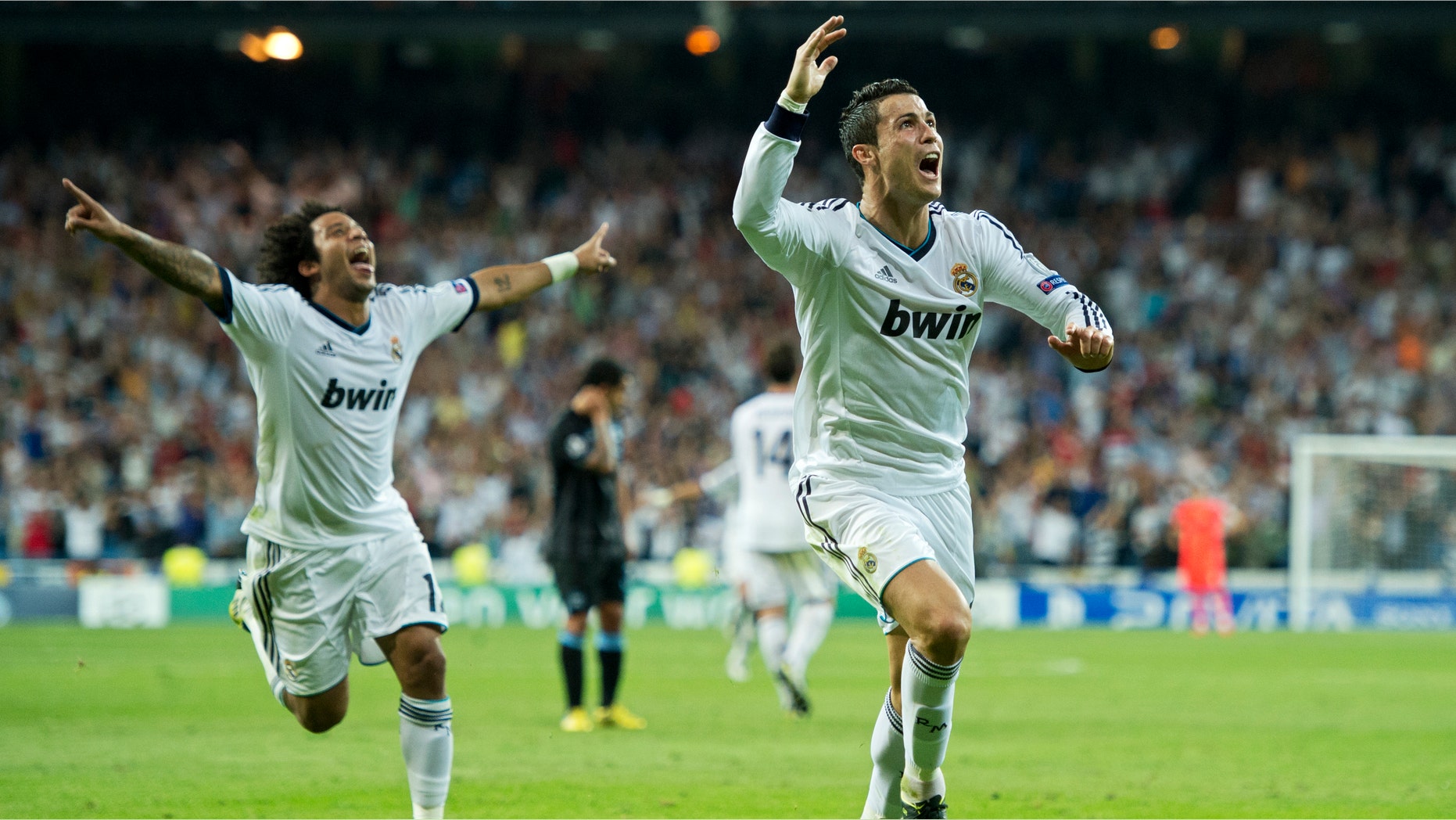 MADRID, SPAIN - SEPTEMBER 18: Cristiano Ronaldo (R) of Real Madrid celebrates scoring his sides winning goal during the UEFA Champions League group D match between Real Madrid and Manchester City FC at the Estadio Santiago Bernabeu on September 18, 2012 in Madrid, Spain. (Photo by Jasper Juinen/Getty Images)