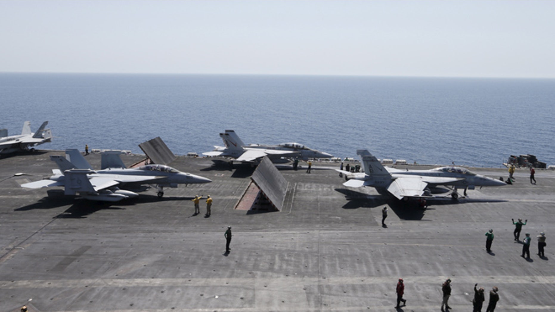 June 18, 2015: F/A-18E/F Super Hornets of Strike Fighter Attack Squadron 211 (VFA-211) are lined up for take off on the flight deck of the USS Theodore Roosevelt (CVN-71) aircraft carrier in the Gulf.