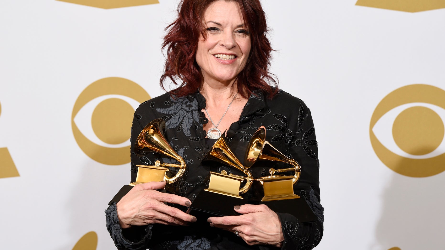 Rosanne Cash poses in the press room with the awards for best American roots performance for A Feather's Not A Bird, best American roots song for A Feather's Not A Bird and best Americana album for The River & The Thread at the 57th annual Grammy Awards at the Staples Center on Sunday, Feb. 8, 2015, in Los Angeles. (Photo by Chris Pizzello/Invision/AP)