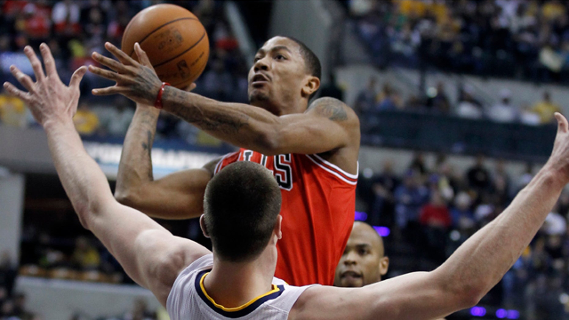 April 12: Indiana Pacers' Tyler Hansbrough (50) tries to draw a charging foul as Chicago Bulls' Derrick Rose drives to the basket during the first half of Game 3 of a first-round NBA basketball series in Indianapolis.