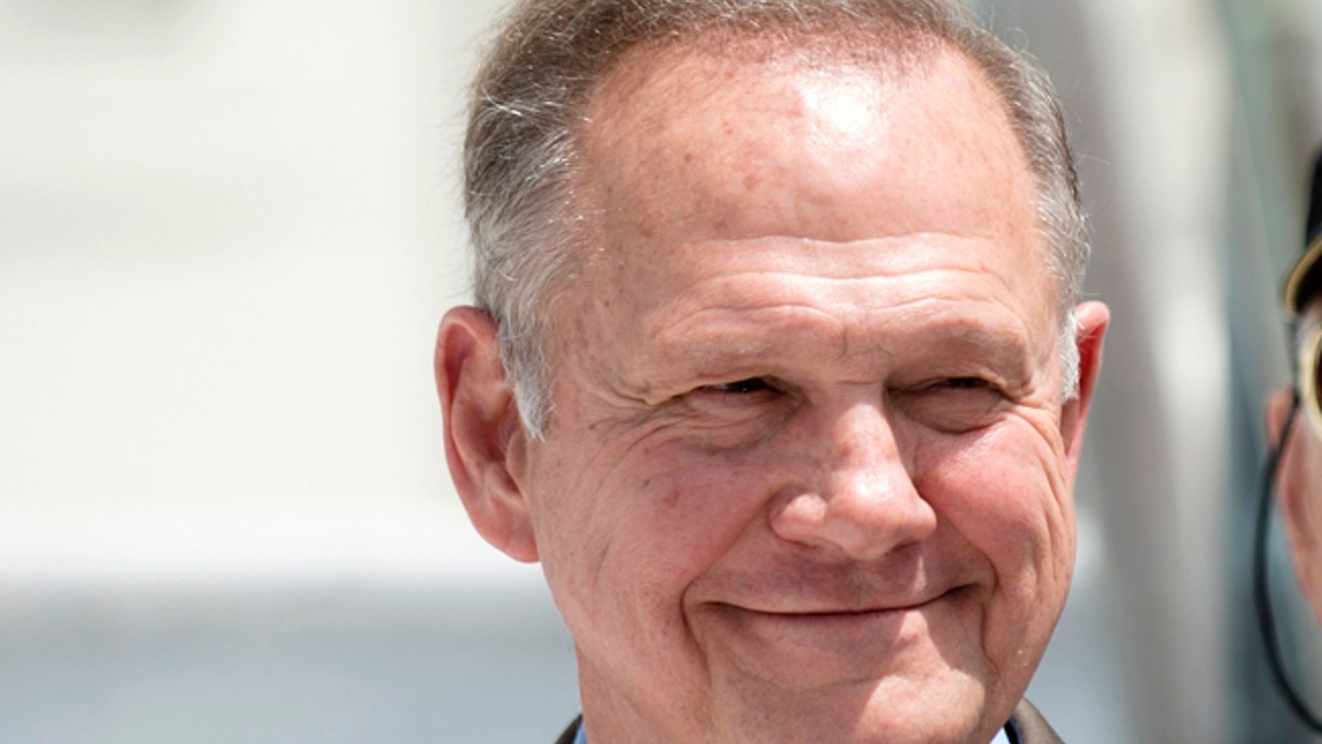 FILE -In this April 26, 2017 file photo, Roy Moore smiles before announcing his Alabama Junior Senate race candidacy, in Montgomery, Ala. As former Alabama Chief Justice Roy Moore, runs for U.S. Senate, he doesn't shrink from telling voters he has twice been ousted from the bench for defying federal courts over the Ten Commandments and same-sex marriage. Instead, he wears those rejections as a badge of honor. (Albert Cesare/The Montgomery Advertiser via AP, File)
