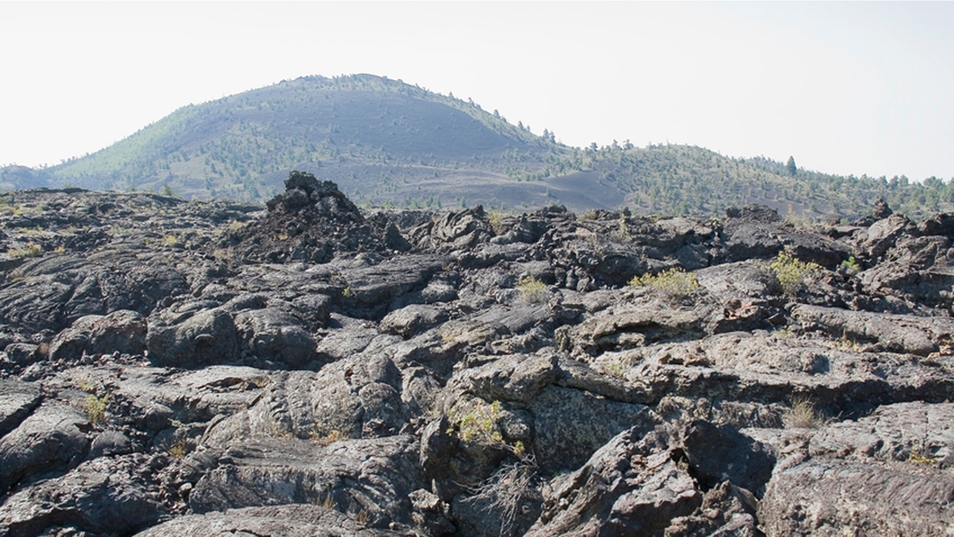 The vast ocean of lava flows through scattered islands of cinder cones and sagebrush at Idaho's space-like Craters of the Moon National Park.