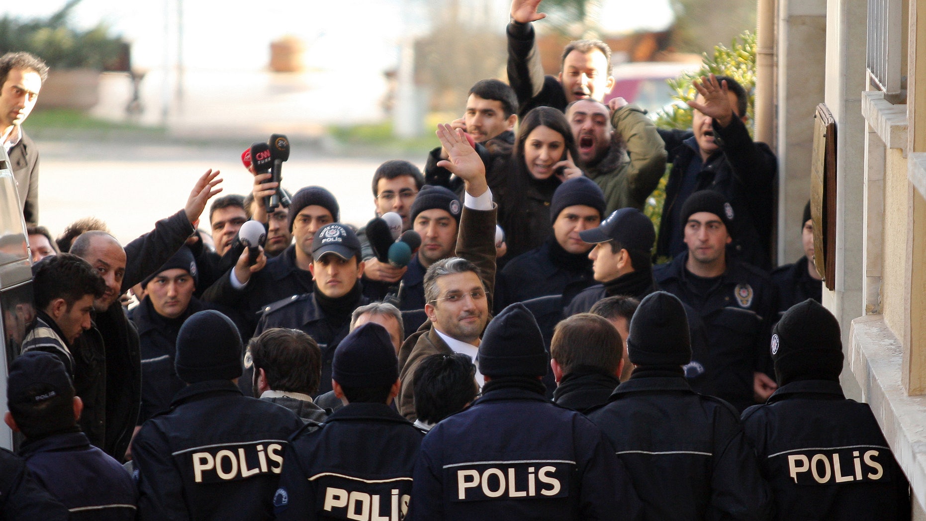 Ahmet Sik (facing camera, third from left) outside an Istanbul courthouse in 2011.