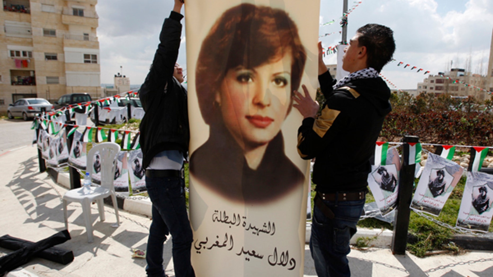 Palestinians in the West Bank town of Al-Bireh decorate a town square with a poster depicting Dalal Mughrabi. The United Nations and Norway have recently taken issue with a women’s center being named after the terrorist responsible for one of the largest terror attacks in Israel’s history.