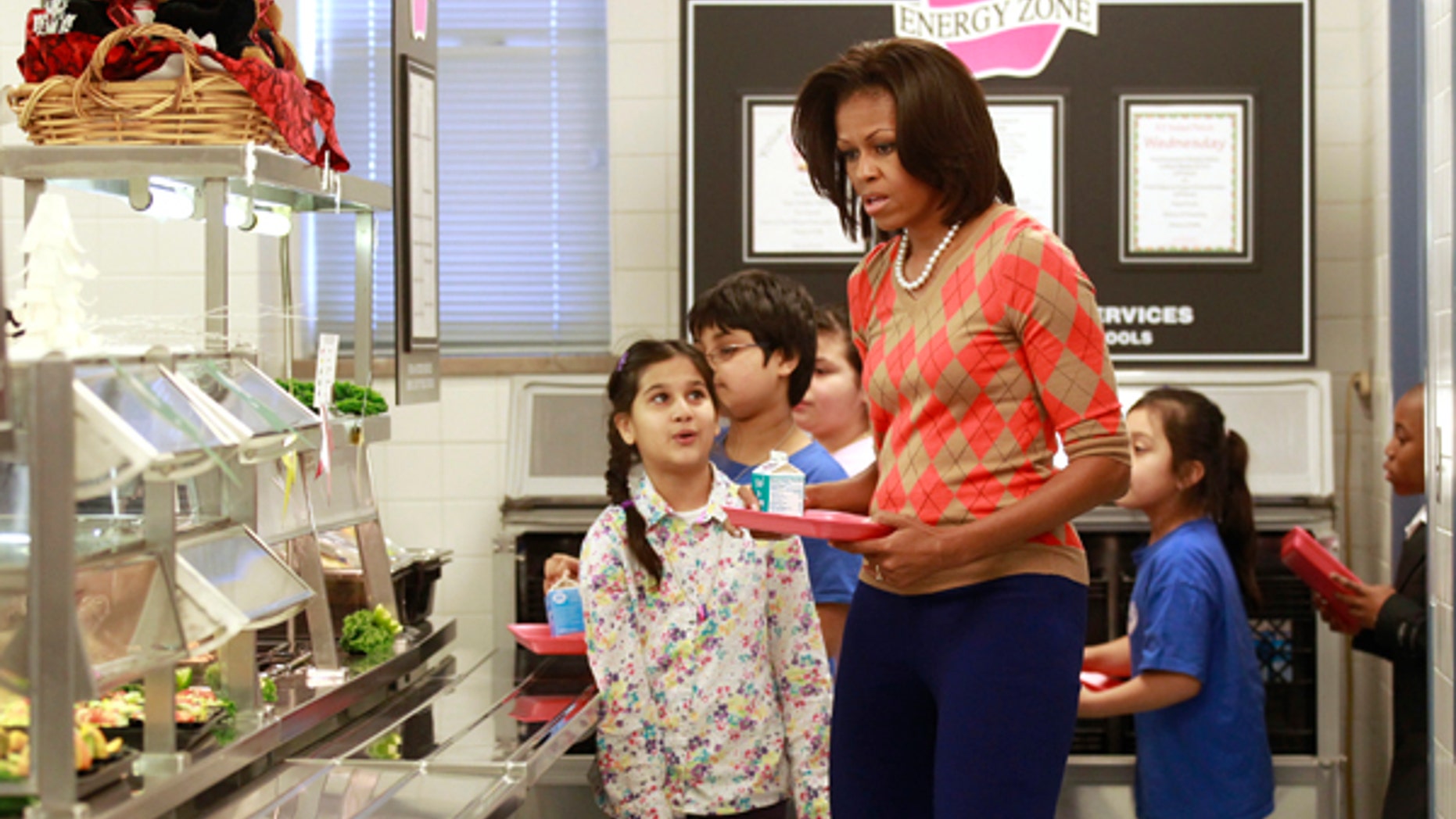 January 25, 2012: U.S. First Lady Michelle Obama joins the lunch line at Parklawn Elementary School in Alexandria, Virginia. Obama made the visit to speak about the United States Department of Agriculture's (USDA) new and improved nutrition standards for school lunches.